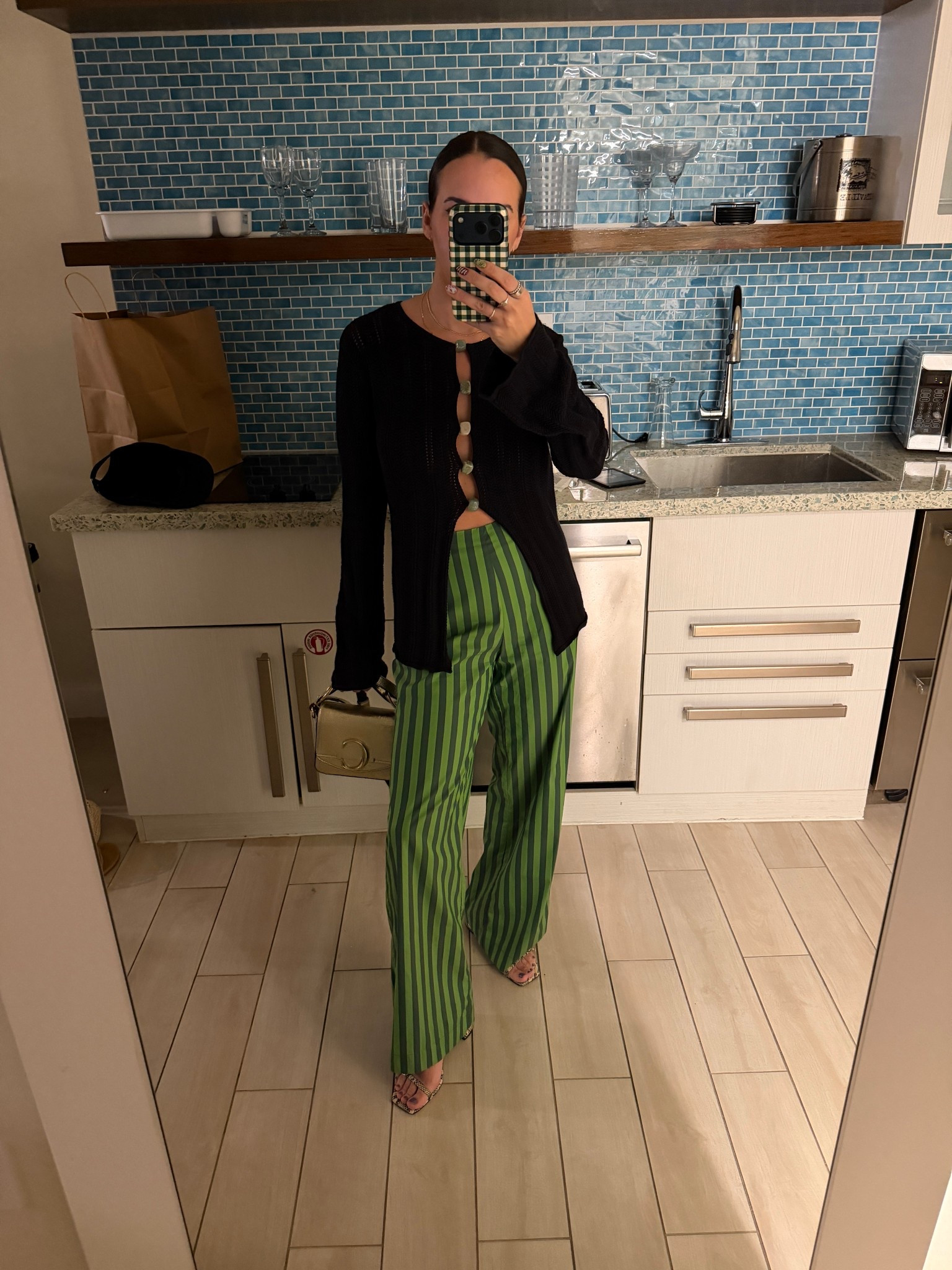 a chic black crochet long sleeve top with rock buttons to create an opening down the middle paired with green striped poplin. pants from simon miller, and snake skin low sandals from Aeyde and a gold chloe bag.

holiday outfit. beach vacation. crochet top. green pants. green stripes. simon miller pia pants. aeyde shoes. gold bag. gold leather bag. fun night out. date night. 

 

#LTKootd #LTKSeasonal #LTKTravel