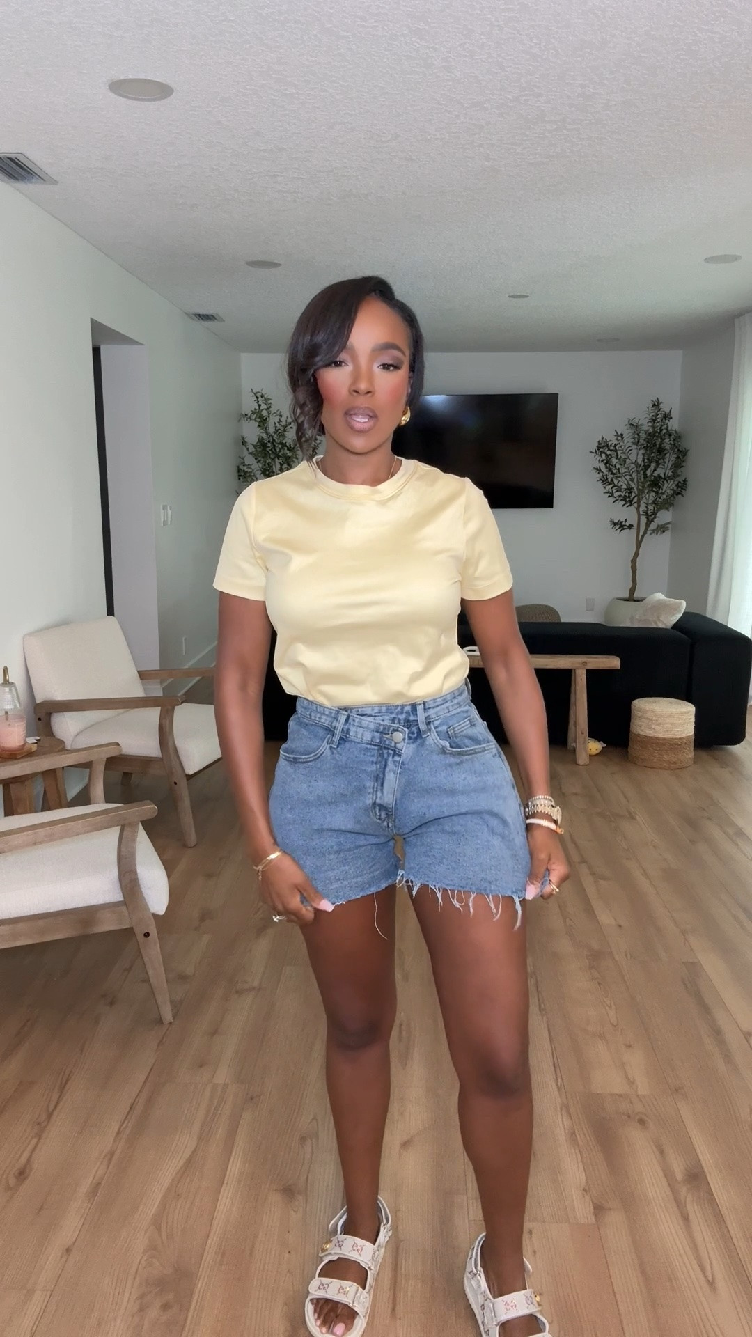 Hi Babes!

This is the kind of outfit I reach for when I want to look effortlessly put together without overthinking it. The buttery yellow tee paired with relaxed denim shorts gives that clean, elevated casual vibe that's perfect for warm weather.

I love how the soft pastel top brightens the entire look while the high-waisted shorts create a flattering silhouette. Add comfortable sandals and simple gold jewelry and you're instantly ready for the day.

Where to wear this:
• Weekend errands
• Coffee runs
• Casual lunch dates
• Summer vacations
• Farmers markets
• School pick-up
• Travel days
• Everyday wear

Undergarments: Nude seamless bra and underwear work best to keep everything smooth under the fitted tee.

Everything is linked below.

xx Kira | IG: KirasFashionFinds

34D - 27 - 40 • Size Small or 4

Follow me on Instagram and YouTube @kirasfashionfinds