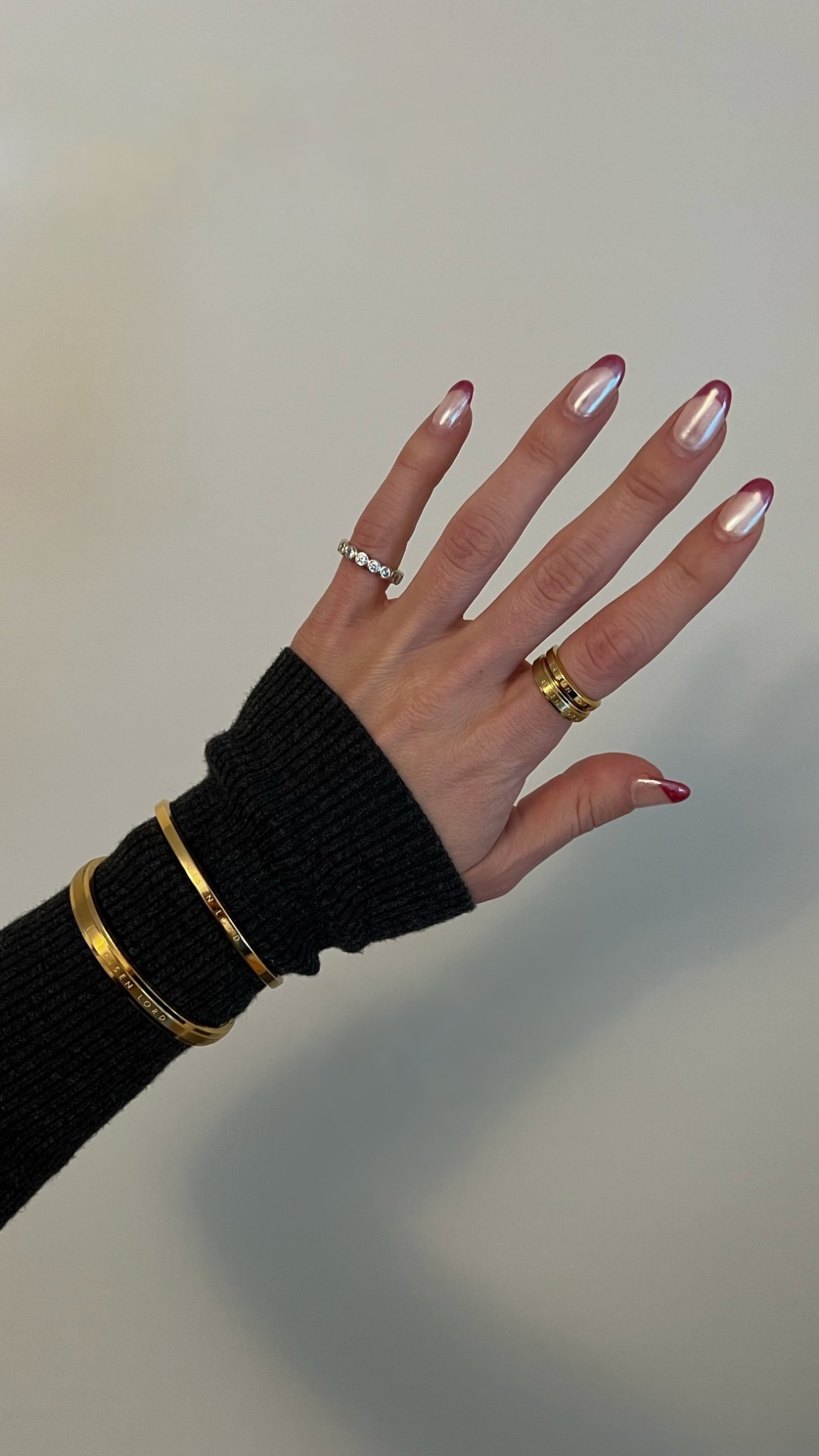 Bracelets and rings on index finger are Risen Lord