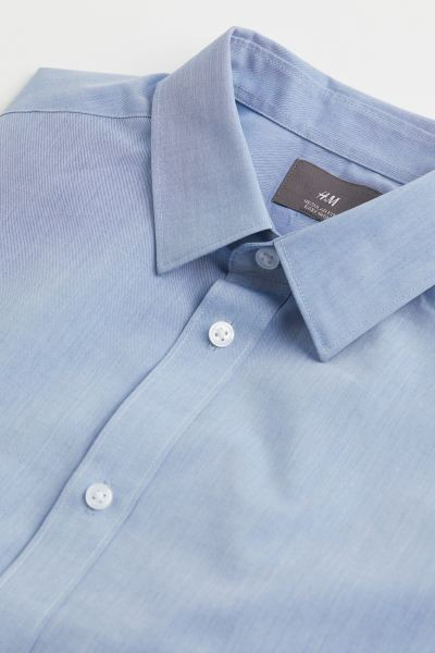 Shirt in woven fabric with an easy-iron finish. Turn-down collar, classic button placket, and yok... | H&M (US + CA)