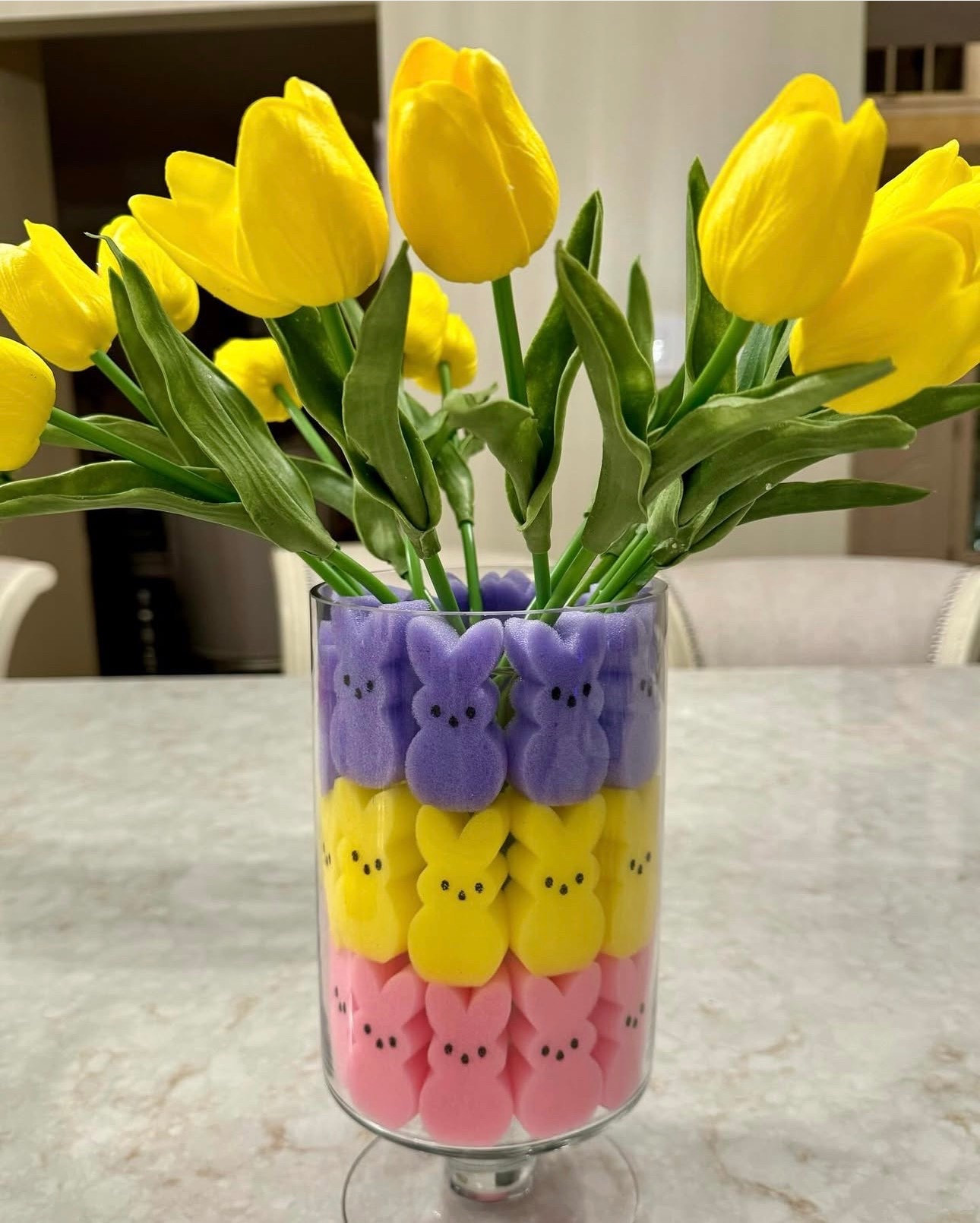 The cutest little Easter centerpiece idea! 🐰🌷 I filled a clear glass vase with colorful sponge Peeps to create layered pastel rows, then added bright yellow tulips for a cheerful spring pop. These lightweight foam bunnies are perfect for decorating because they hold their shape and can be reused year after year. Such an easy way to add a playful touch to your kitchen island, coffee table, or Easter brunch table. Simple, festive, and very JustJennsDesign style!


#LTKhome #LTKspring #LTKseasonal #Easterdecor #Springdecor #Eastercenterpiece #Peepsdecor #Pasteldecor #Springtablescape #Eastertable #Seasonaldecor #DIYdecor #Springstyling #Easterinspo #JustJennsDesign