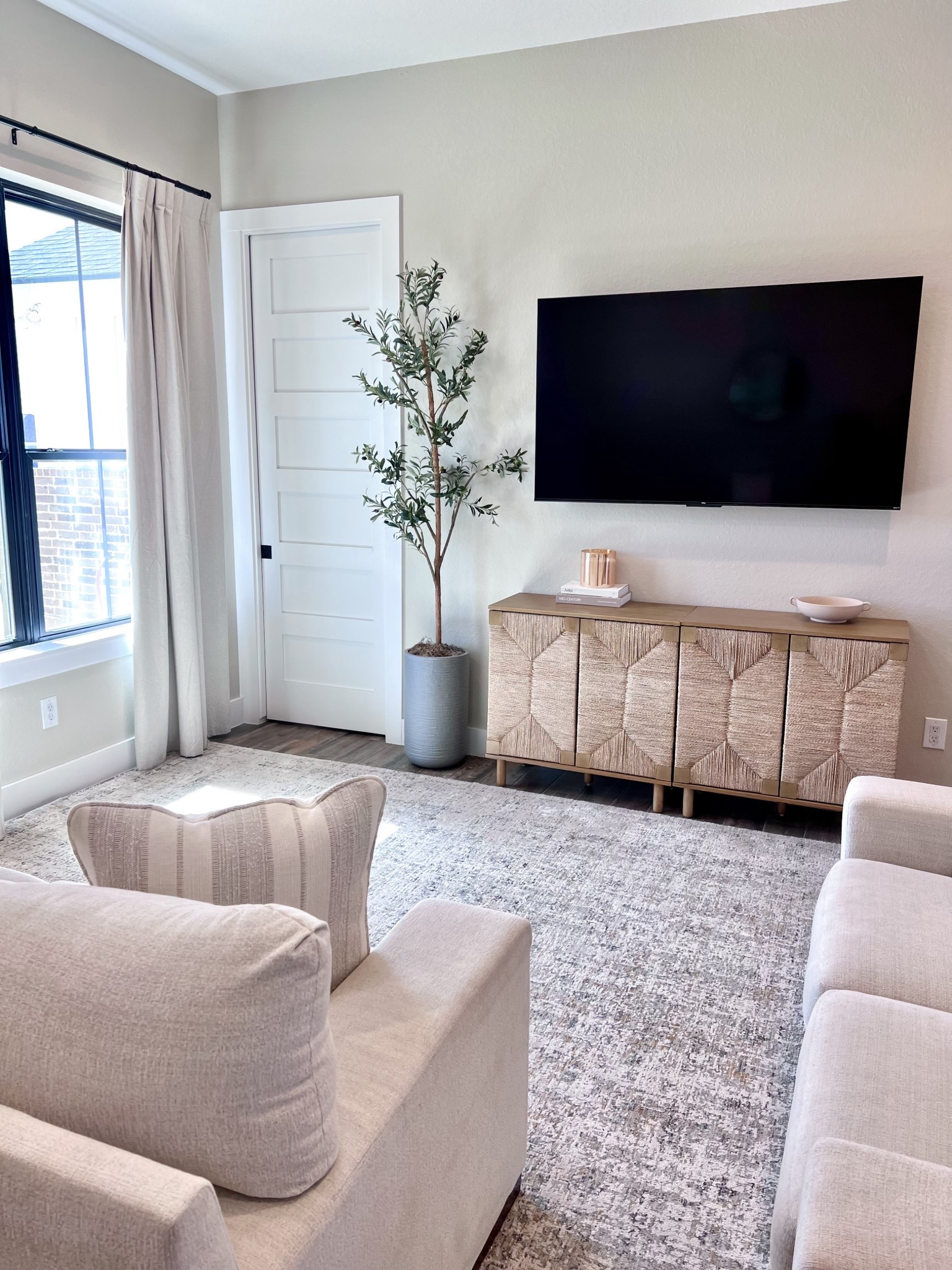 I’m slowly adding to this small living room space! I think I want to replace the curtains with a light blue or gray to give the space more color, but still neutral.  

Home decor, living room, neutral couch, neutral area rug, faux olive tree, tv, entertainment furniture, small home 

#LTKHome