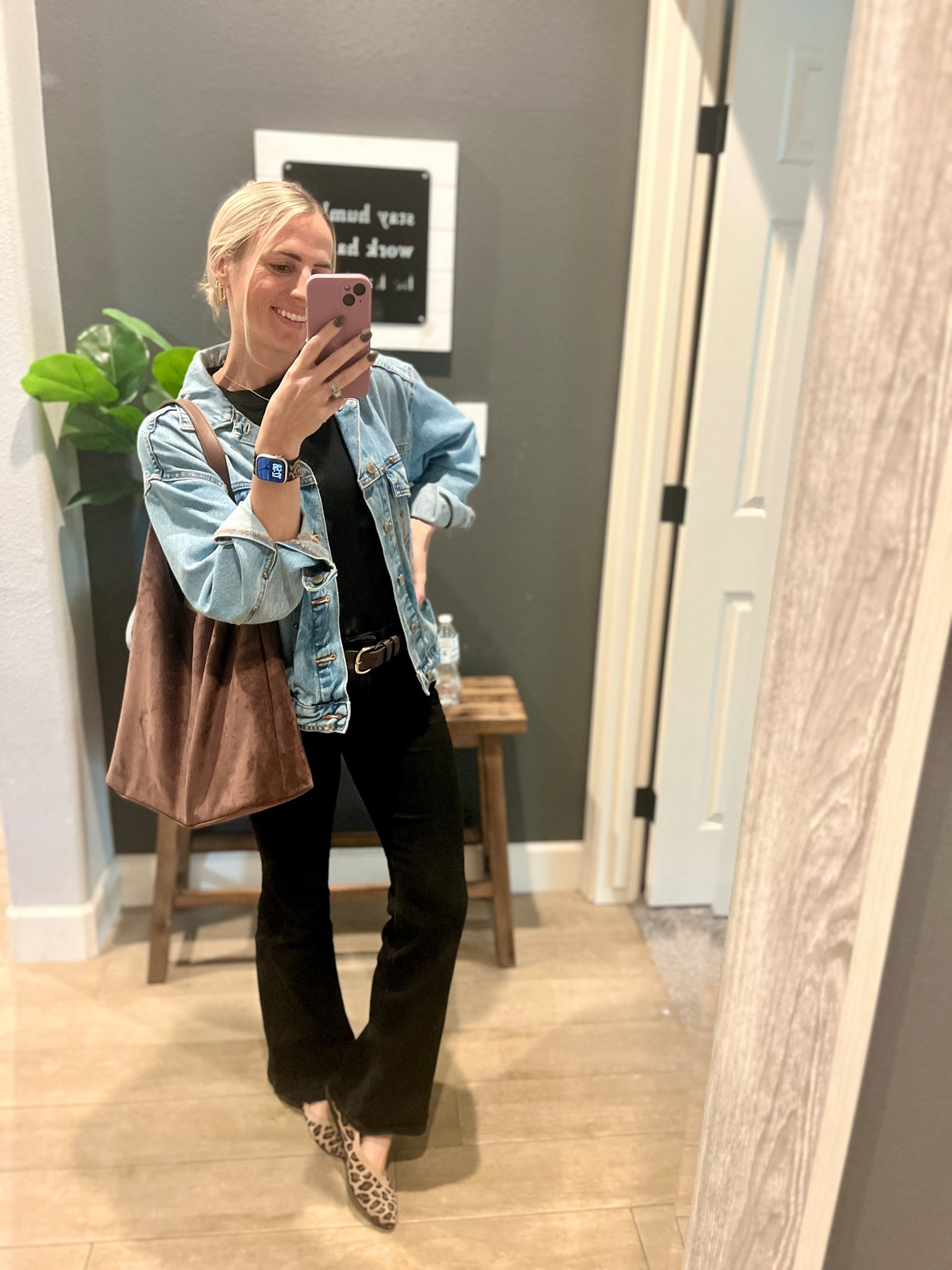 Recreate the look! 

Black flares 
Slim fitting black tee 
Brown belt 
Leopard shoes 
Denim jacket 
Suede bag 

If exact isn’t available, I’ll link similar! 