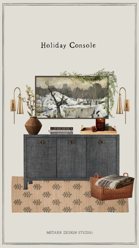 A curated holiday tv console look, with faux jasmine garland, brass sconces, a large clay plant pot with faux winter stems, gold tray with auburn candle, stacked coffee table books, a festive jute runner, wicker basket to hold checkered throw blankets, and frame tv with winter tv art  

#LTKhome #LTKHoliday #LTKSeasonal