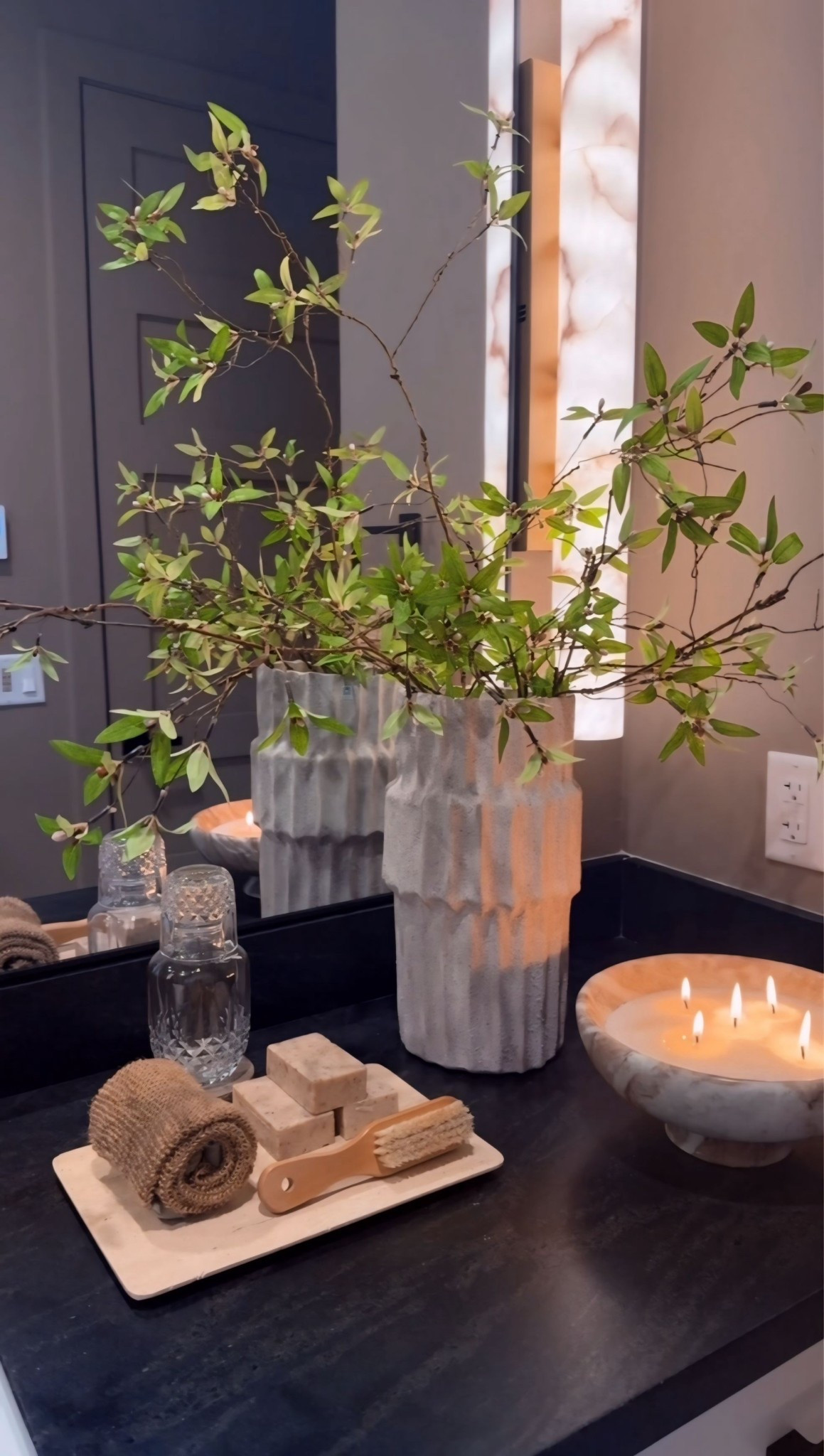 It’s the smallest details that turn a bathroom into a calming retreat. A textured vase with soft green stems adds a natural touch, while a marble bowl and travertine tray layer in those spa-like materials. Finished with a beautiful soap display, this simple table styling brings that quiet, spa feeling right into your home.

bathroom counter styling
spa bathroom decor
travertine tray decor
marble bowl decor
bathroom vanity styling 🕊️🌿