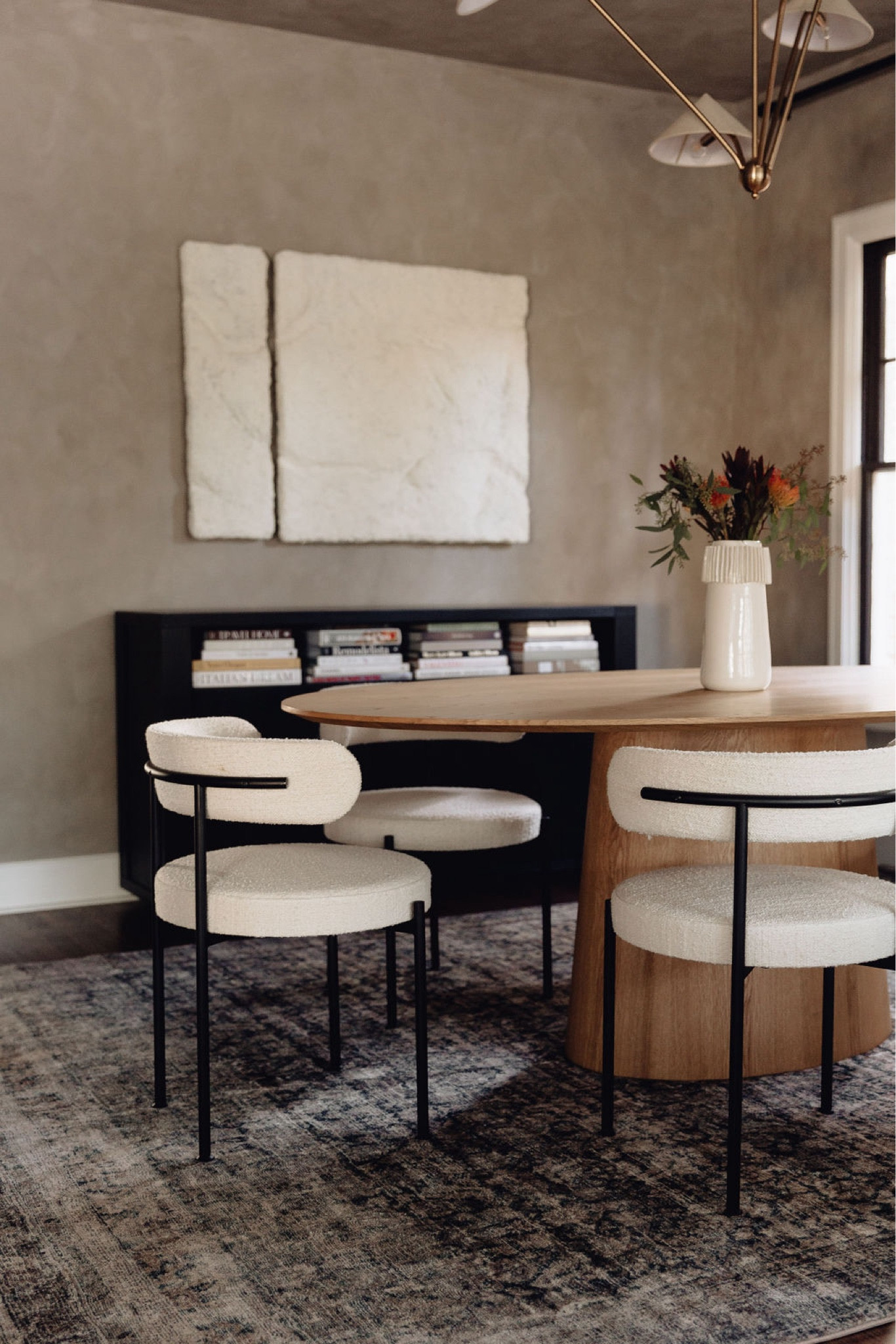 Dining room // home decor, dining room decor, dining room chairs, dining room table, candle holder, pampas grass, candleholders, dining table, chandelier, mirror, CB2, dried eucalyptus, vase, faux sheepskin, candles, table runner, Amazon home decor, modern home decor, modern decor, tablescape, modern home decor, neutral home decor, dining room, dining room decor, living room, living room decor