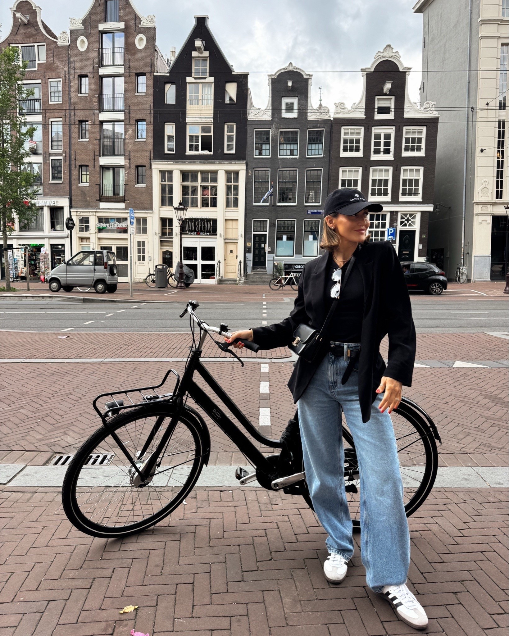 Euro summer outfit idea! 🤍 I wore this look during a bike day in Amsterdam on one of my latest Europe trips. I found a few jean options that look similar and are on sale at the moment. I love the slight barrel leg fit and think an oversized blazer is a great staple to pack on a big trip. Throw on a baseball hat so you don't have to style your hair every day (one of the best travel hacks) and finish off with comfy white sneakers, like these Adidas Sambas.