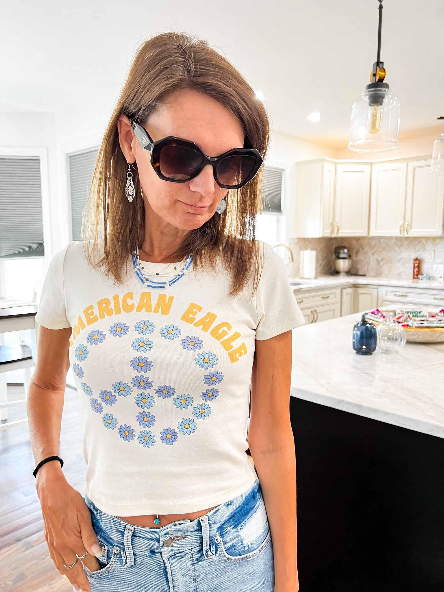 American Eagle cropped tee with daisy’s and peace sign now on clearance under $8. American Eagle necklaces, daisy necklaces, beaded necklace. 

#LTKfindsunder50 #LTKstyletip #LTKsalealert