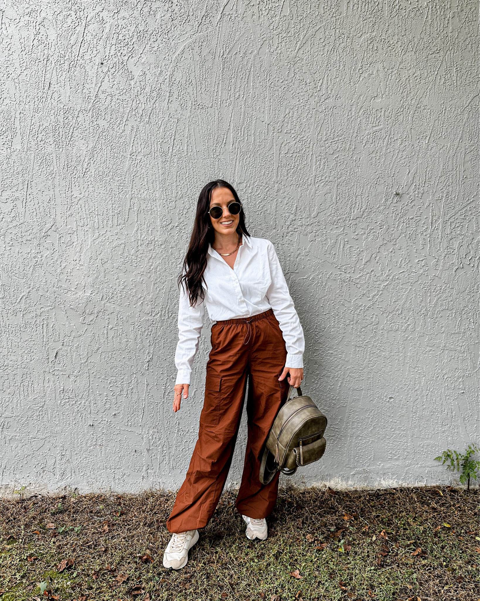 White collar button up
Terracotta loose cargo pants 
New balance tennis shoes
Little green backpack 
Round brown sunglasses 


#LTKItBag #LTKStyleTip #LTKShoeCrush