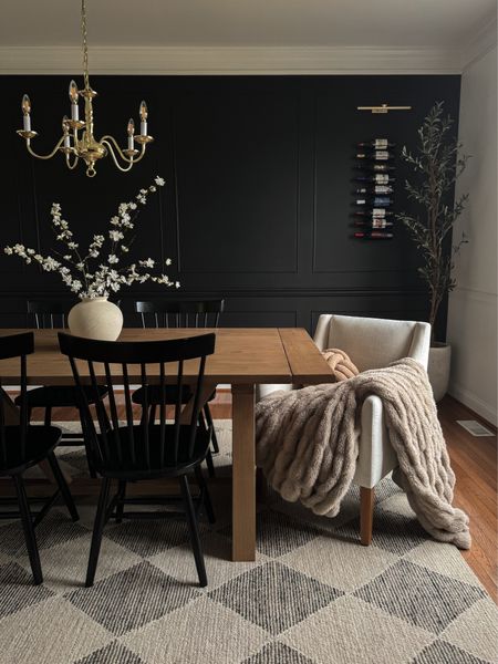 Simple spring dining room refresh. 

Table: World Market in Light Graywash
Accent wall color: Black Magic by Sherwin Williams 
Vase is from Hobby Lobbyy

Dining room decor, spring stems, moody dining room, dining table decor, black dining chairs, accent dining chairs, dining room rug, wine bottle display, black accent wall, olive tree
