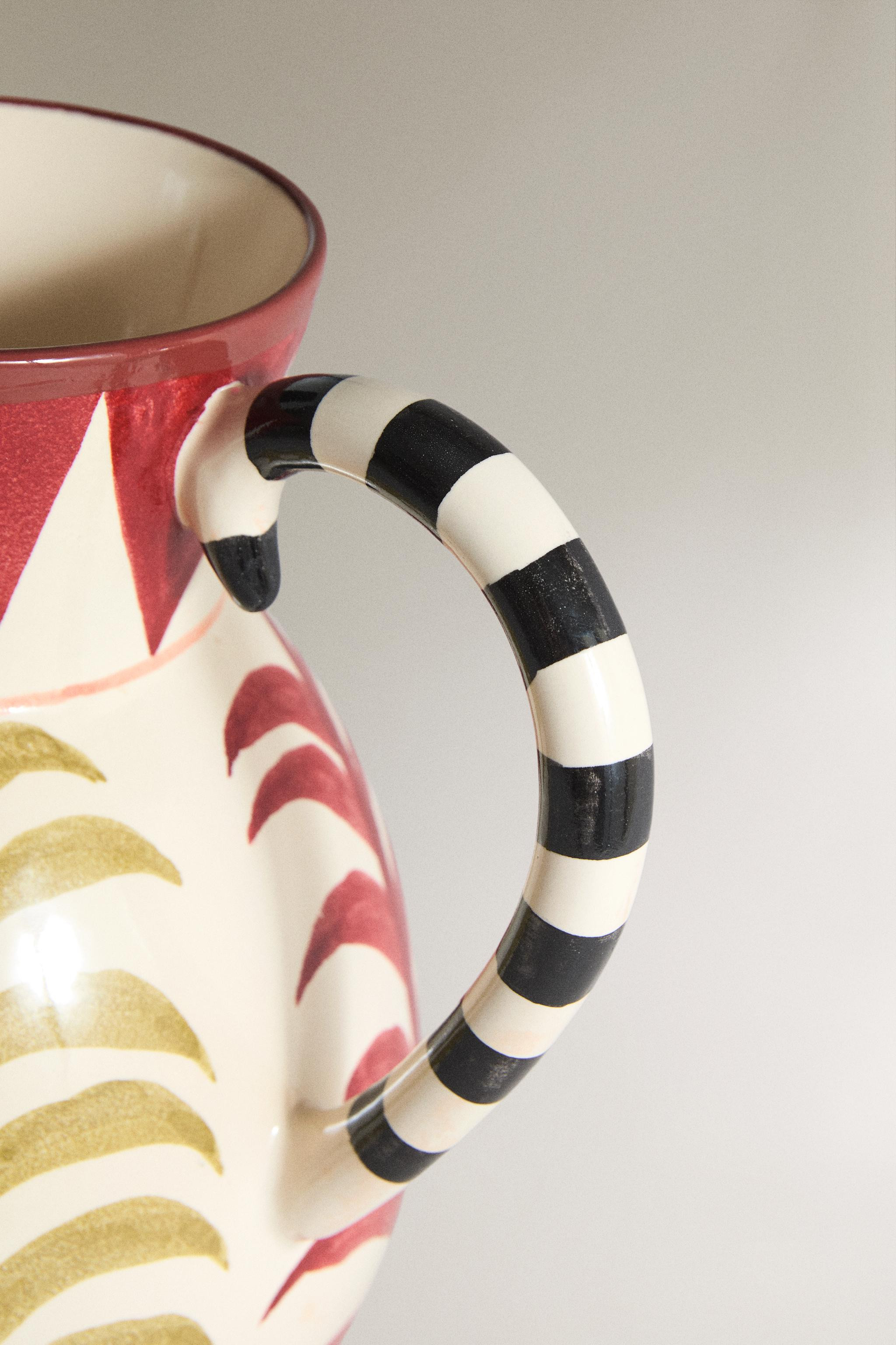 Contrast striped ceramic vase with double side handle. Amphora-shaped design with plant motifs an... | Zara UK