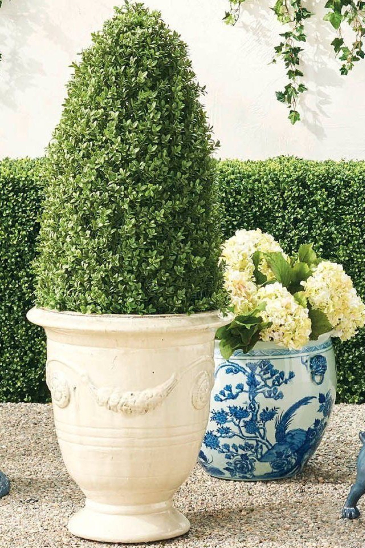 Urn planter boxwood cone topiary outdoor planters front porch 

#LTKstyletip #LTKhome #LTKsalealert