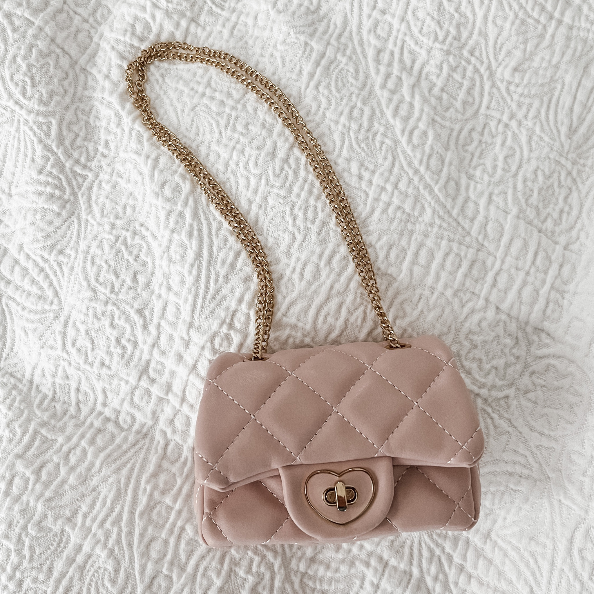The cutest little designer-lookalike purse for playing dress up. The twist clasp is functional, the chain can be used doubled up or long, and it feels surprisingly well made. This tiny handbag a huge hit with our 21 month old! #LTKtoddler #LTKtoys

#LTKkids