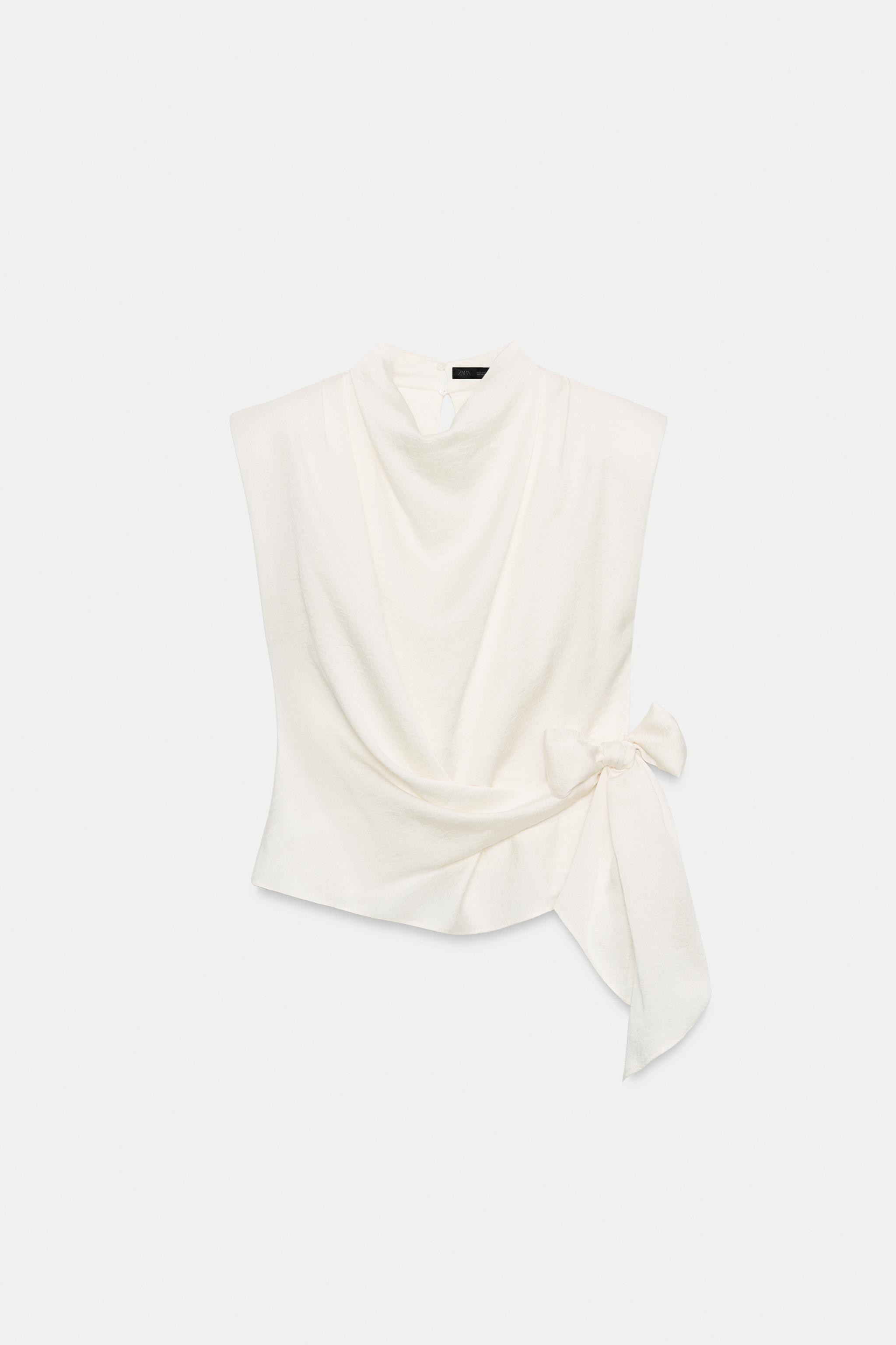 Model height: 181 cmSleeveless top with a high neck, shoulder pads and pleats. Featuring a knot d... | Zara UK
