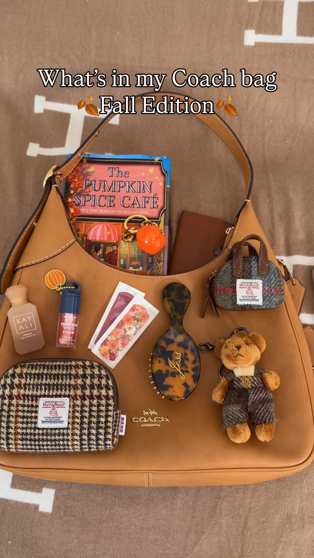 What fits in the Coach Outlet Ella ♥️ Comment SHOP & I’ll dm you the links 🍂

What’s in my bag:
Pumpkin spice cafe book
Harris tweed pouch from Amazon
Bath and body works pumpkin cold foam lip gloss
Cleaning wet wipes 
Fall bandaids
KayAli mini perfume 
Personalized mini hairbrush 
Mini Harris tweed zipper 
AirPod chain connector