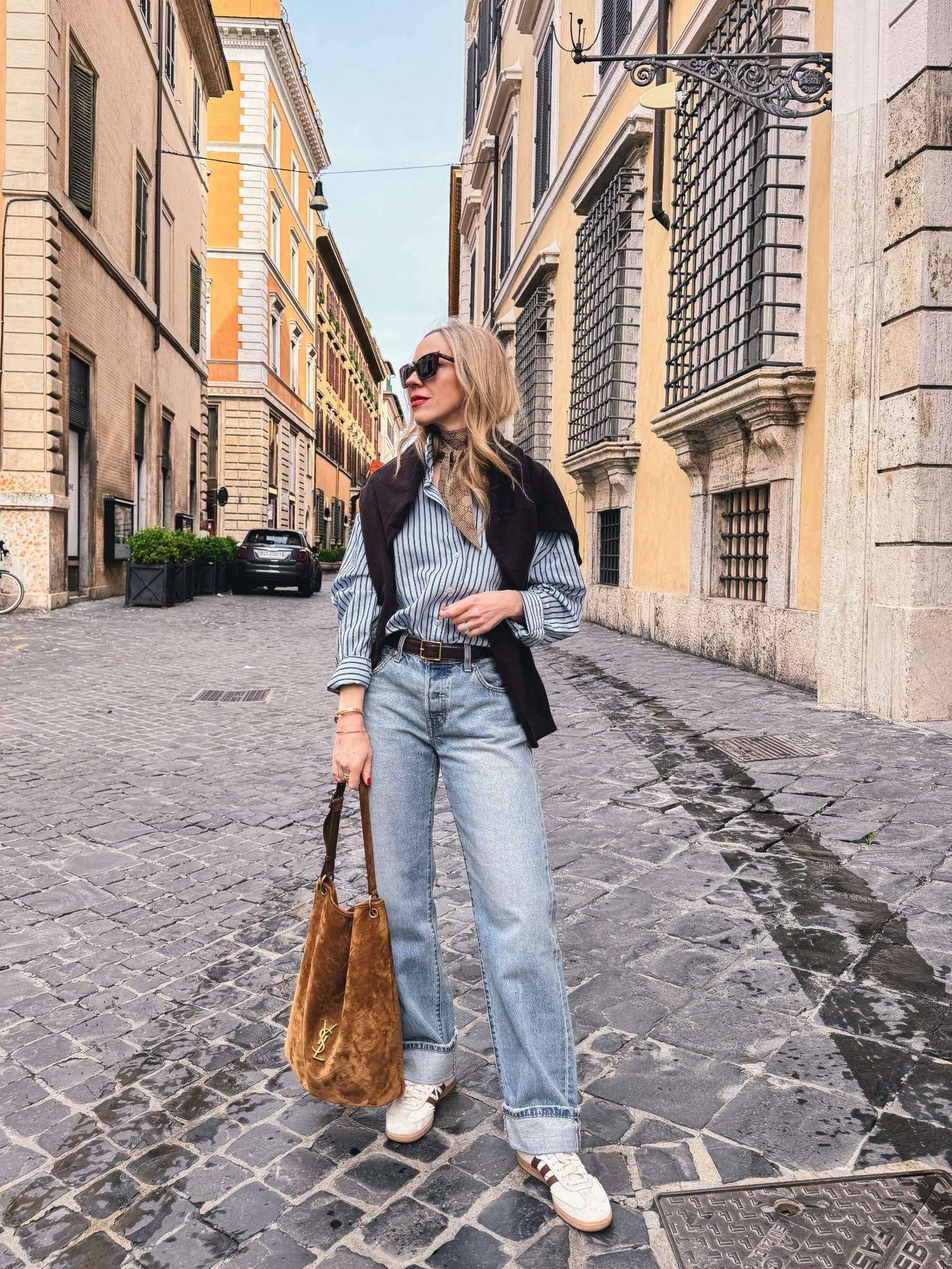 European travel look, chocolate brown and baby blue, spring outfit, @Zara striped shirt, @Levi's cuffed baggy 90’s jeans, Adidas Samba sneakers, suede YSL  bucket bag

#LTKTravel #LTKSeasonal #LTKOver40