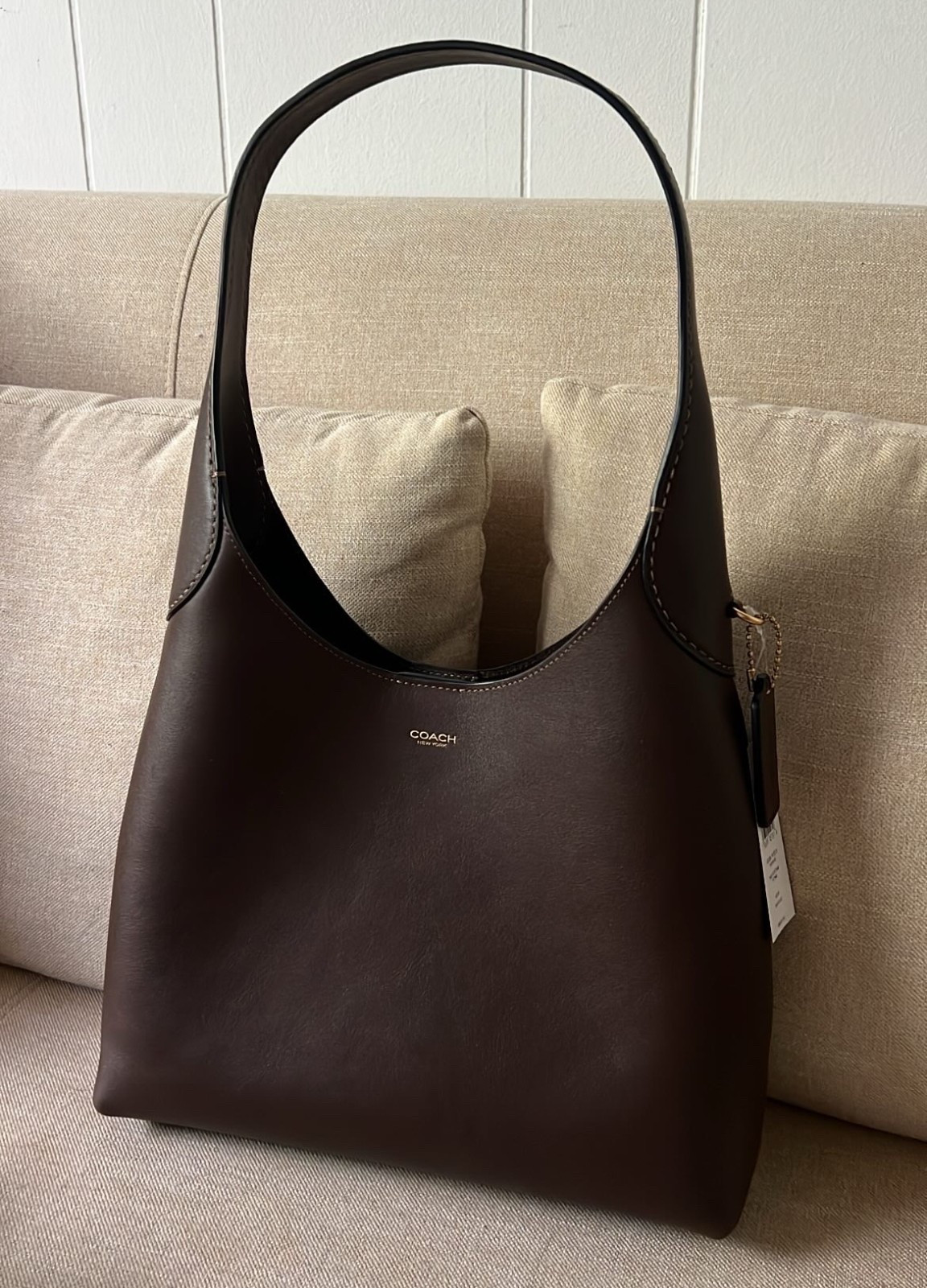 This sleek Coach shoulder bag is the definition of timeless elegance. The rich chocolate brown leather makes it the perfect everyday handbag that pairs effortlessly with casual and dressy looks. A must-have designer accessory for anyone building a chic, minimalist wardrobe. #CoachBag #DesignerStyle #LTKFinds #LTKBag #MinimalistWardrobe

#LTKStyleTip #LTKItBag #LTKWorkwear