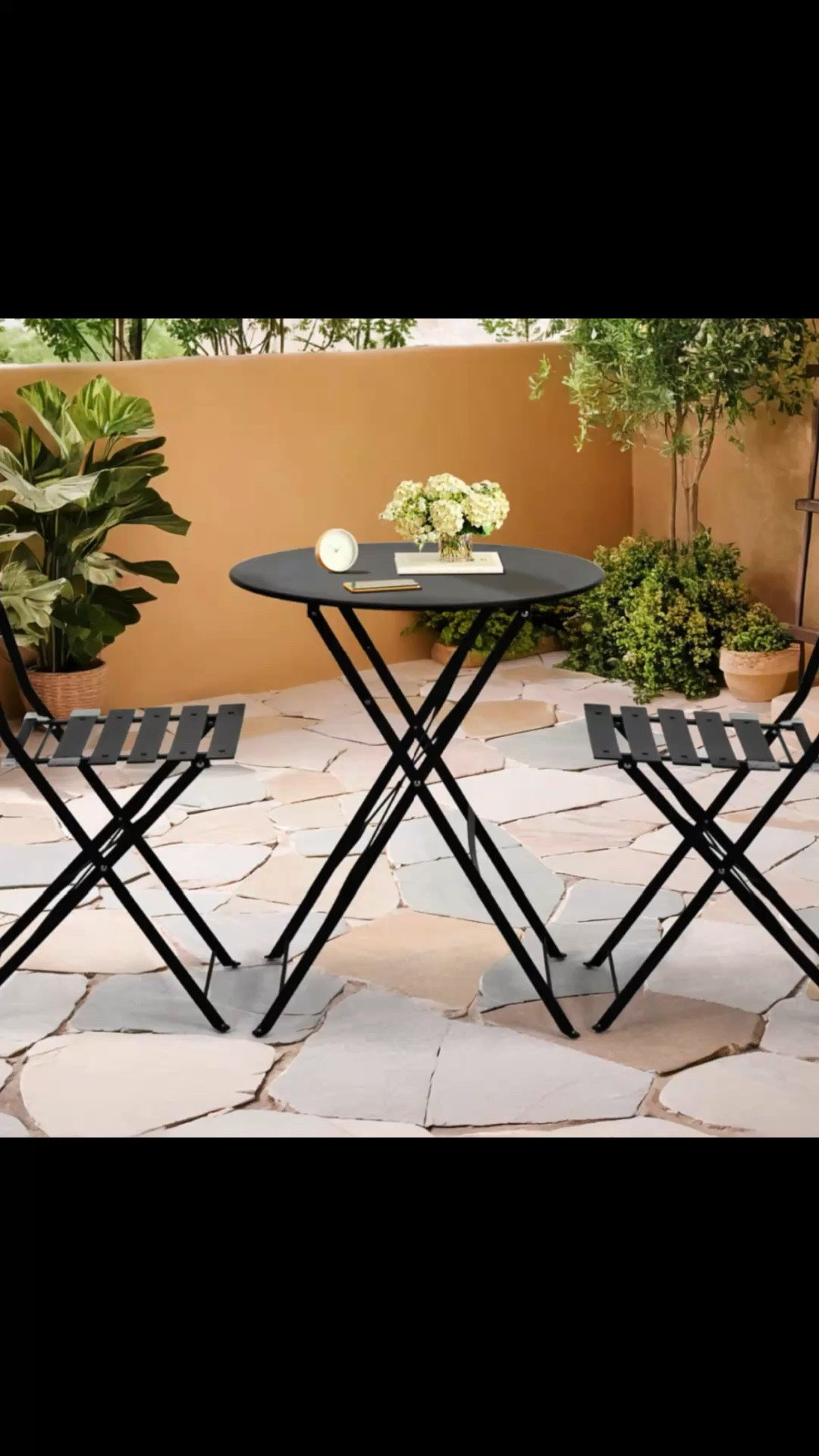This 3-piece set features powder-coated metal with a clean, lightweight design that works well in outdoor spaces. It includes a round bistro table and two coordinating chairs that all fold flat for quick setup and easy storage when not in use. The chairs offer wide, slatted seats and backrests for added comfort, and each one supports up to 330 lbs. Plastic foot pads help protect hard surfaces and come with a bonus set for future use. We love that this set is easy to move around – perfect for flexible seating on patios or balconies.

Features
    •    Includes foldable table and two chairs for compact storage and portability
    •    Powder-coated metal frame with wide slatted seats for comfort and durability
    •    Plastic foot pads help protect floors – bonus replacement set included

#LTKHome #LTKSeasonal