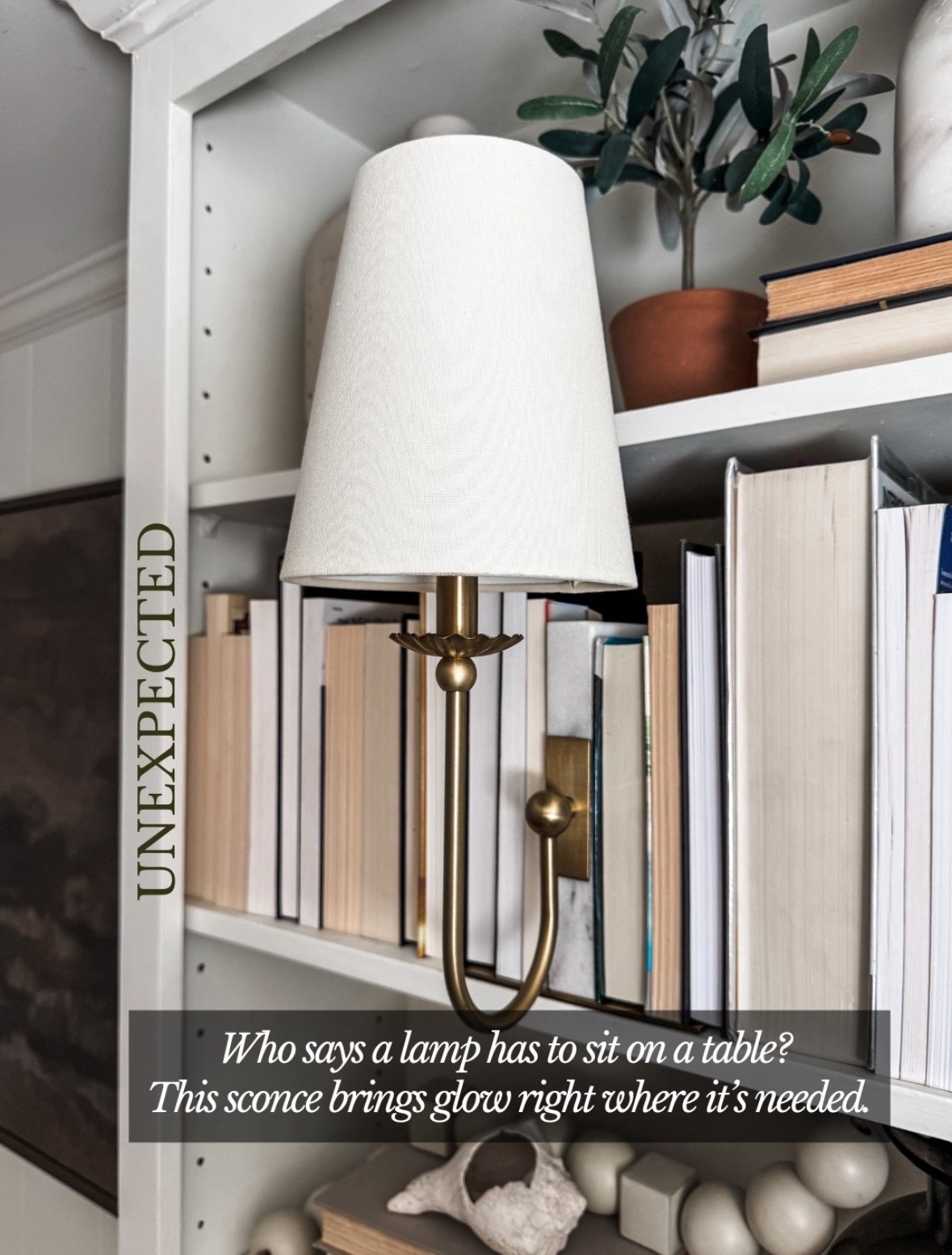 Unexpected lighting moments are always my favorite 🤍
This brass wall sconce with a fabric lampshade adds the perfect soft, ambient glow without taking up any surface space. Styled right into built-in bookshelves, it layers beautifully with neutral decor, stacked hardcover books, ceramic objects, and a potted olive tree for a warm, collected look. A classic library sconce like this brings function and charm to home offices, reading nooks, or styled shelving, proving great lighting doesn’t have to live on a table. Linked on LTK ✨

#eanesinteriors #wallsconce #brasslighting #fabriclampshade #shelflighting #builtinbookshelves #librarylighting #ambientlighting #neutraldecor 

#LTKstorytime #LTKHome #LTKOver40