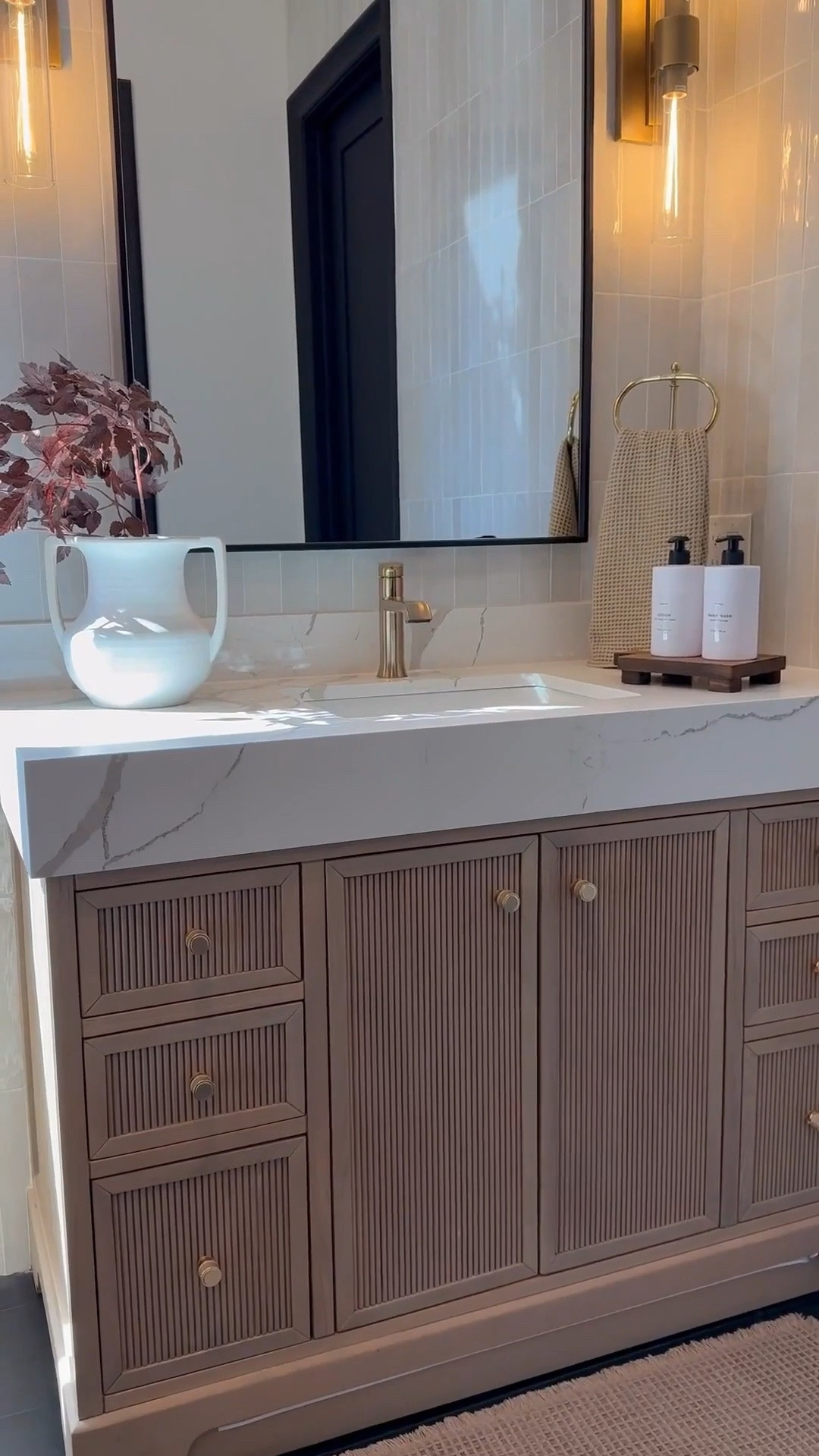 My bathroom vanity feels so warm and inviting with a few seasonal accents like these cimicifuga stems 🌿 The brown accent chair adds the perfect cozy tone 🪑 and I love how the backsplash and vanity combo keep everything neutral while still adding warmth 🤍

My artwork has been such a favorite 🎨 available in so many sizes and styles, it’s perfect 🤩 I’m also obsessed with my white oak console and dining tables that carry that same warmth throughout my home. And this vintage-inspired vase is so versatile, it works beautifully as a planter and adds that timeless look.🏺✨