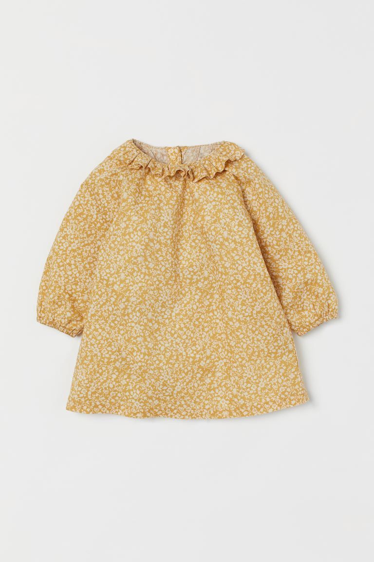 Baby Exclusive. Dress in woven organic cotton fabric. Ruffled collar, buttons at back, and long r... | H&M (US + CA)