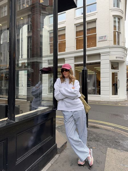 Red cap, grey sweatshirt, striped trousers, red new balance trainers, sunglasses, shoulder tote bag

#LTKeurope #LTKSeasonal #LTKstyletip