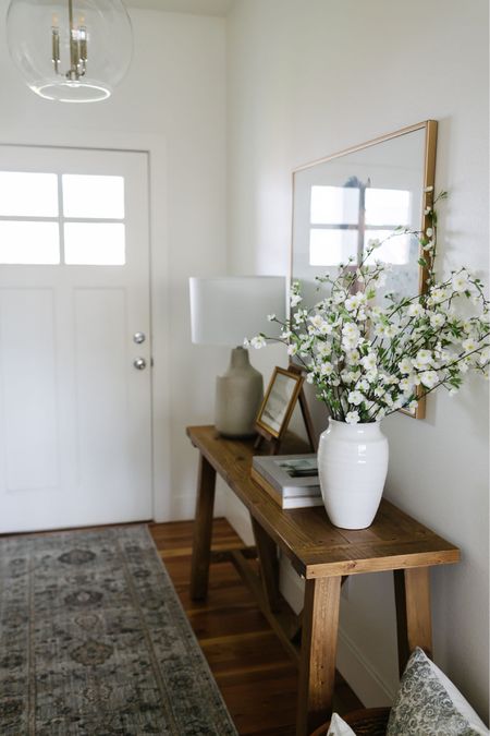 An entryway table perfect for spring through summer with a white vase filled with faux stems, a wood console table and affordable entryway rug  

#LTKsalealert #LTKFind #LTKhome