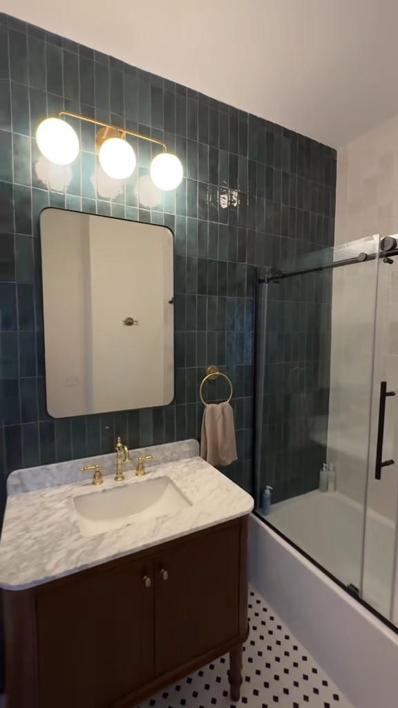 Our guest bathroom remodel before & after!! Looking at the transformation of this space is still crazy to me 😍 I’m so happy with how the room turned out and that we were able to bring my vision to life 🪄 I love the three light fixture above the dark brown vanity and of course the green tile accent wall  

#LTKHome #LTKFindsUnder100