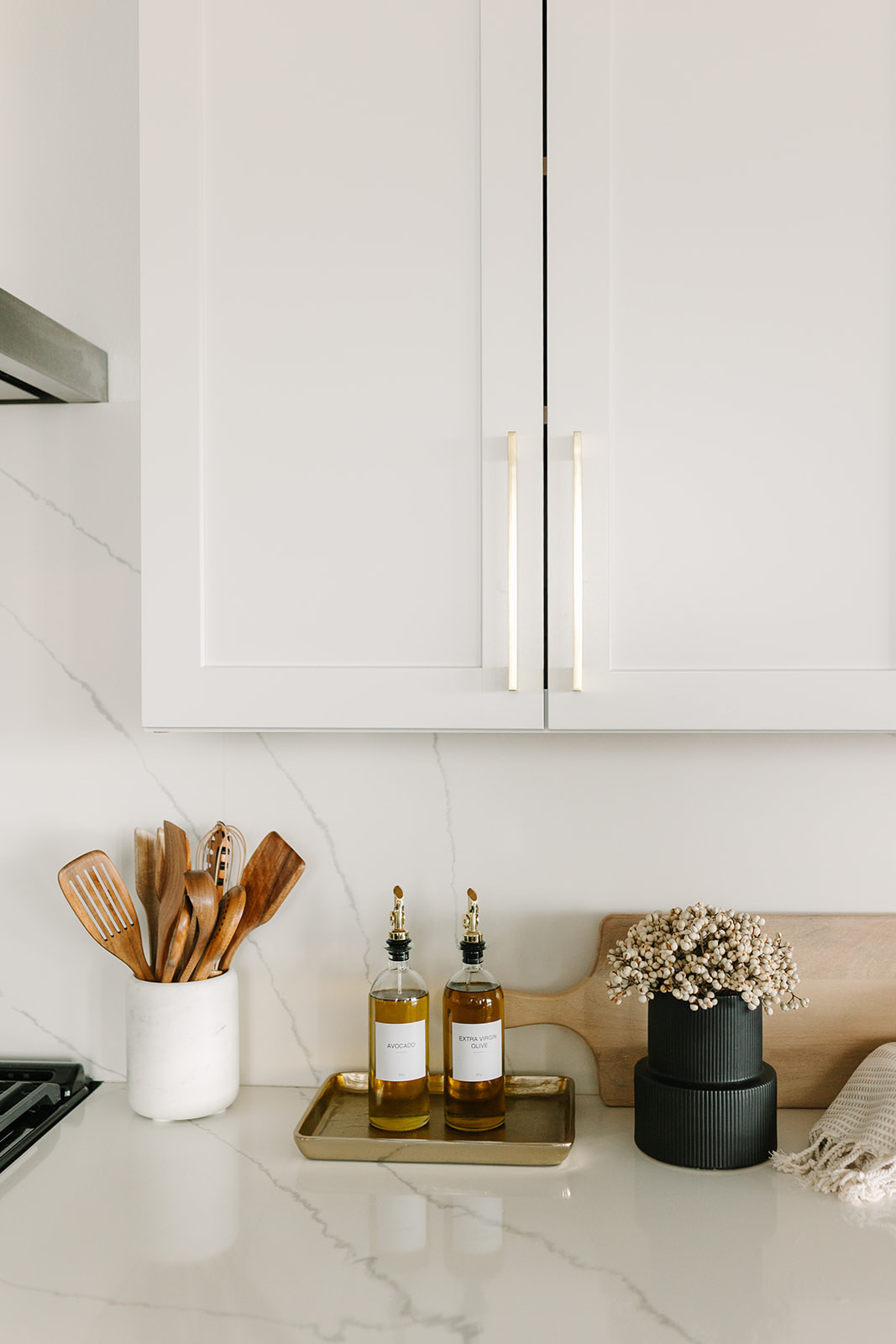 Kitchen counter styling 🤍 Pretty and convenient pieces like wooden utensils and olive oil jars I use every day. 

 #LTKHome
