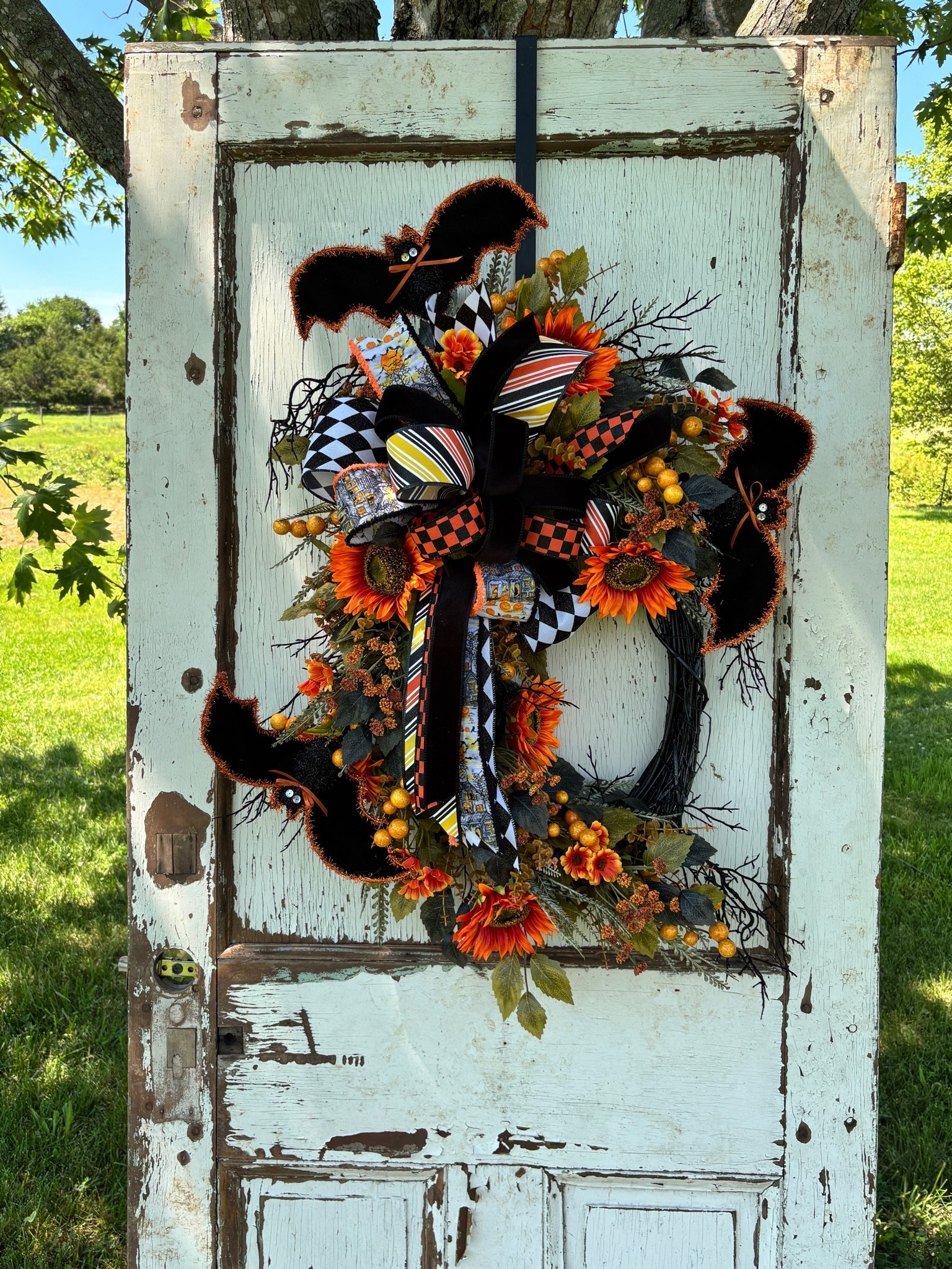 🧡🖤 Spooky season starts at the front door! This handmade Halloween wreath is full of vibrant orange sunflowers, fuzzy bats, festive ribbons, berries, and whimsical Halloween accents on a black grapevine. It’s the perfect statement piece to welcome guests, trick-or-treaters, and everyone who loves a little Halloween magic.

Handcrafted with care and ready to ship, this one-of-a-kind design will add the perfect mix of spooky and fall charm to your home.

#LTKHome #LTKSeasonal #LTKU