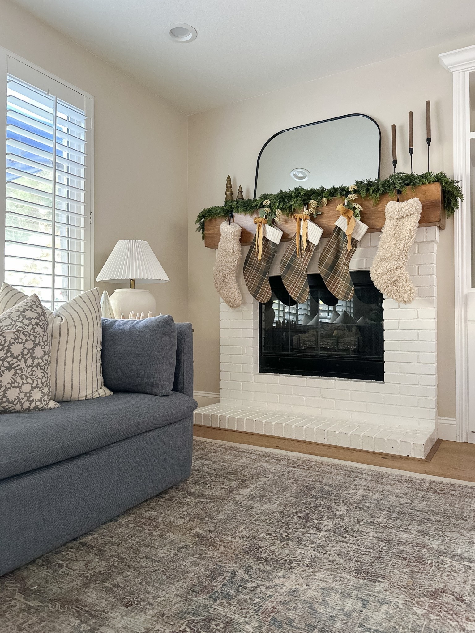 Simple decorated holiday mantel 

Fuzzy stockings
Plaid stockings
Real touch full garland
Loloi rug
Blue sofa 

#LTKSaleAlert #LTKHoliday #LTKHome
