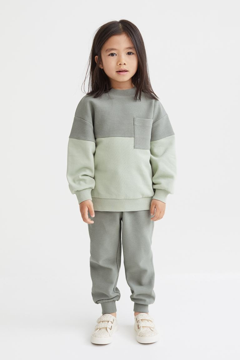 Set with a top and pair of coordinating joggers in soft fabric. Top with sections in fluted sweat... | H&M (US + CA)