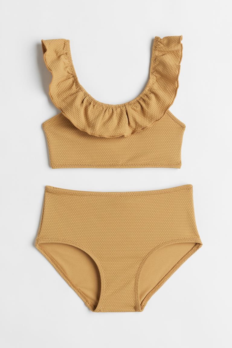 Conscious choice  Kids Exclusive. Fully lined, textured bikini. Top with an overlocked flounce at... | H&M (US + CA)