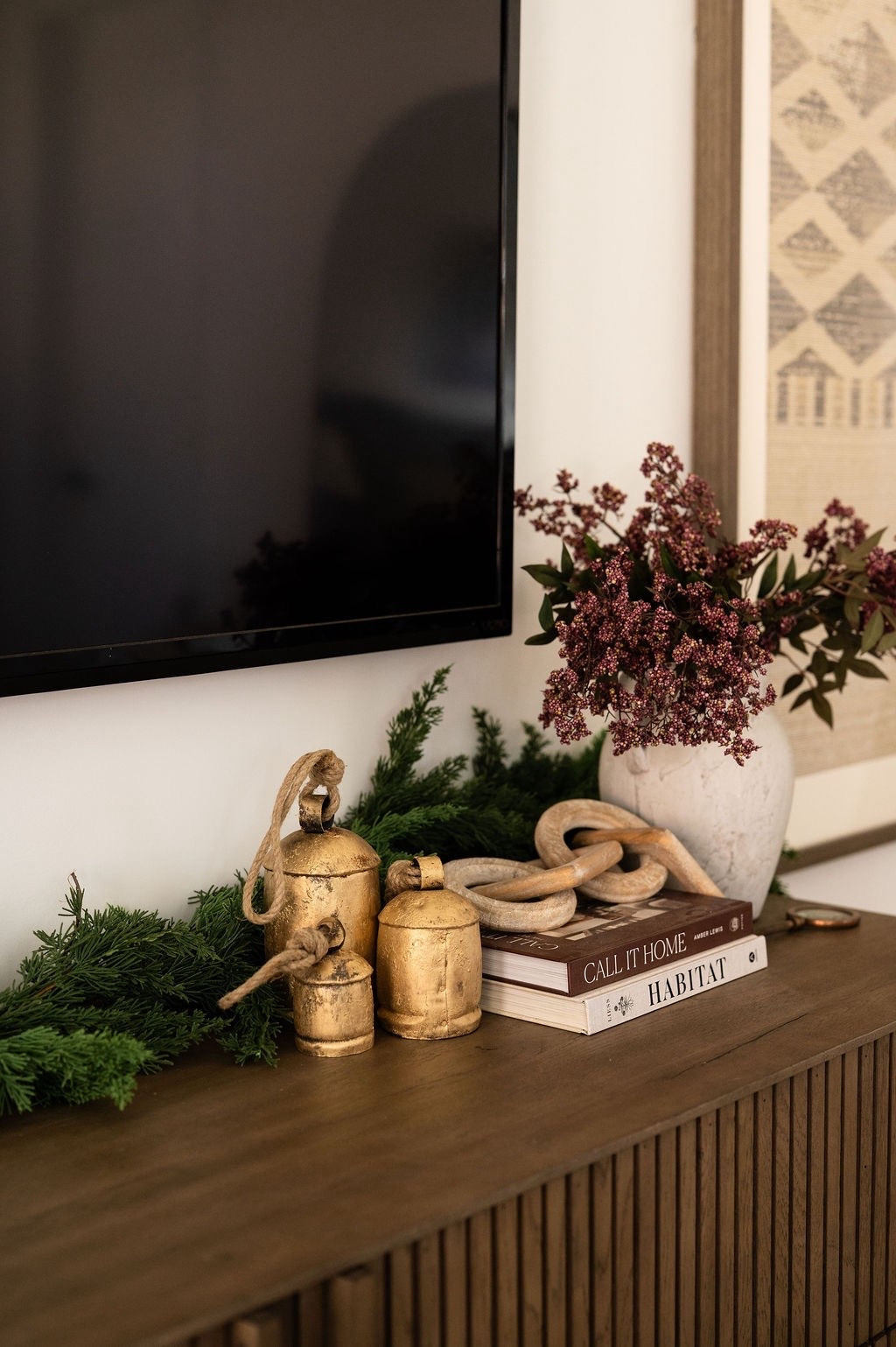 Loving these cozy Christmas details in my bedroom on my dresser 🎄🕯️ The mix of antique-style gold bells, natural garland, wood links, and seasonal florals creates such a warm and collected look. Beautiful ideas for winter home decor, Christmas console table styling, holiday accent decor, neutral holiday styling, and organic Christmas decor. ✨

#LTKHome #LTKHoliday #LTKSeasonal