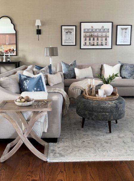 Living room styling. Sofa & area rug on sale, mirror on sale, cozy and comfy throw pillows and blankets, Parisian artwork, tray, vase, marble candleholders, sconce set, candle.

#LTKfindsunder50 #LTKsalealert #LTKhome