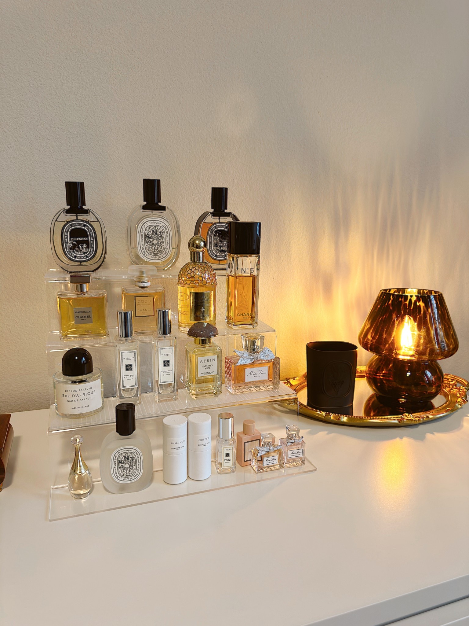 On my fragrance shelf - my favorite perfumes & most worn fragrances. My signature scent is Eau des Sans by Diptyque, I’ve been wearing it for years! It’s the perfect combination of refreshing yet warm & grounding. Not too sweet yet not heavy. It’s so unique and my complimented scent on my shelf  

#LTKBeauty #LTKSeasonal #LTKHome