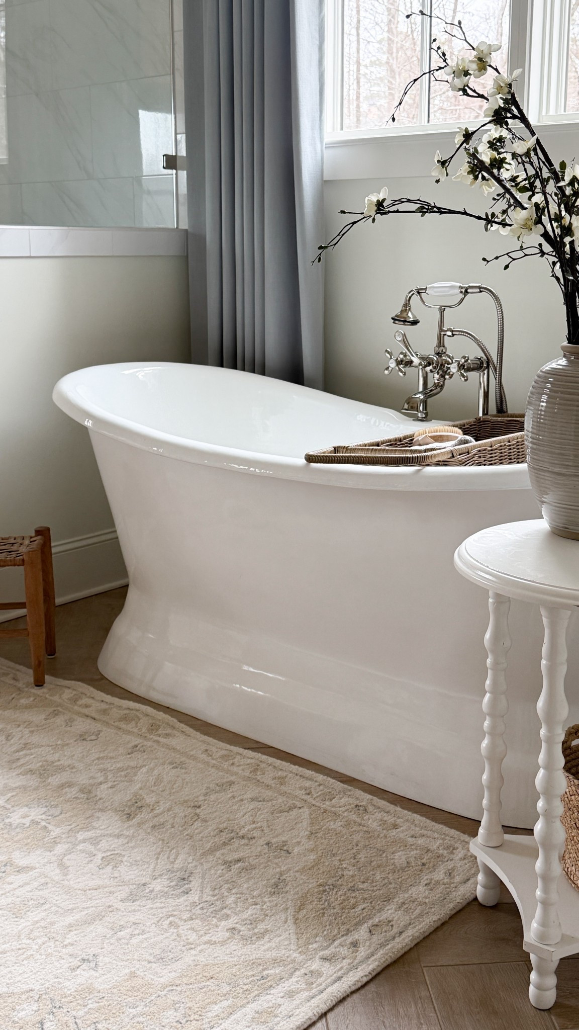 Primary bathroom moment 🤍

Other than the wood look tile floor, there was a lot of white happening in this space. I love a light and airy bathroom, but it was missing some warmth, texture, and a little color.

Over the last year I slowly added a few pieces that made a big difference: a wool rug, these soft blue curtains, and a woven rattan bath caddy. They bring in texture and warmth while still keeping the calm, airy feel I love.

Our double slipper tub has been discontinued, but I’ll link similar options below.

#LTKHome #LTKstorytime