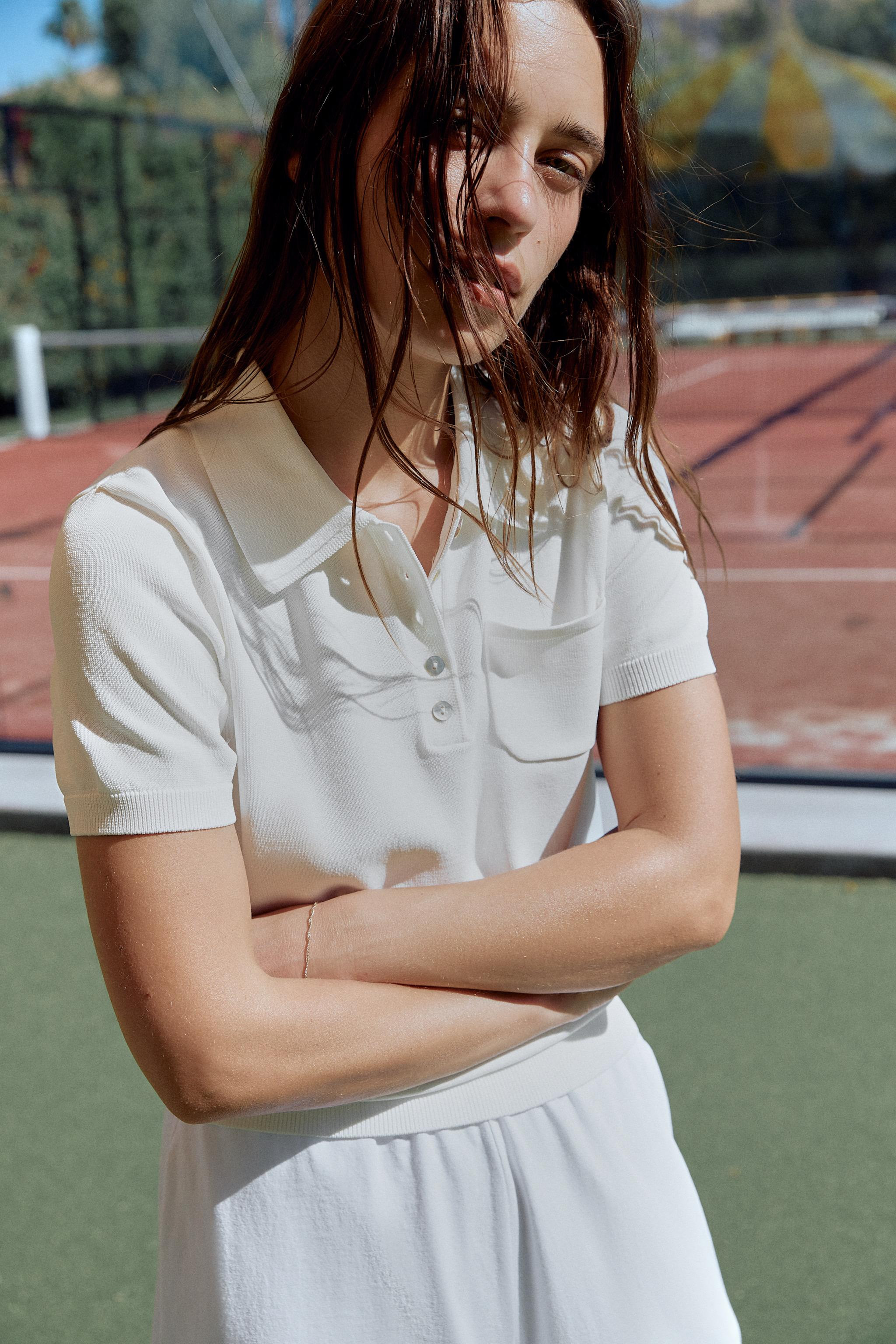Polo neck top with short sleeves. Front patch pocket. Front buttons. Ribbed trim. | Zara US