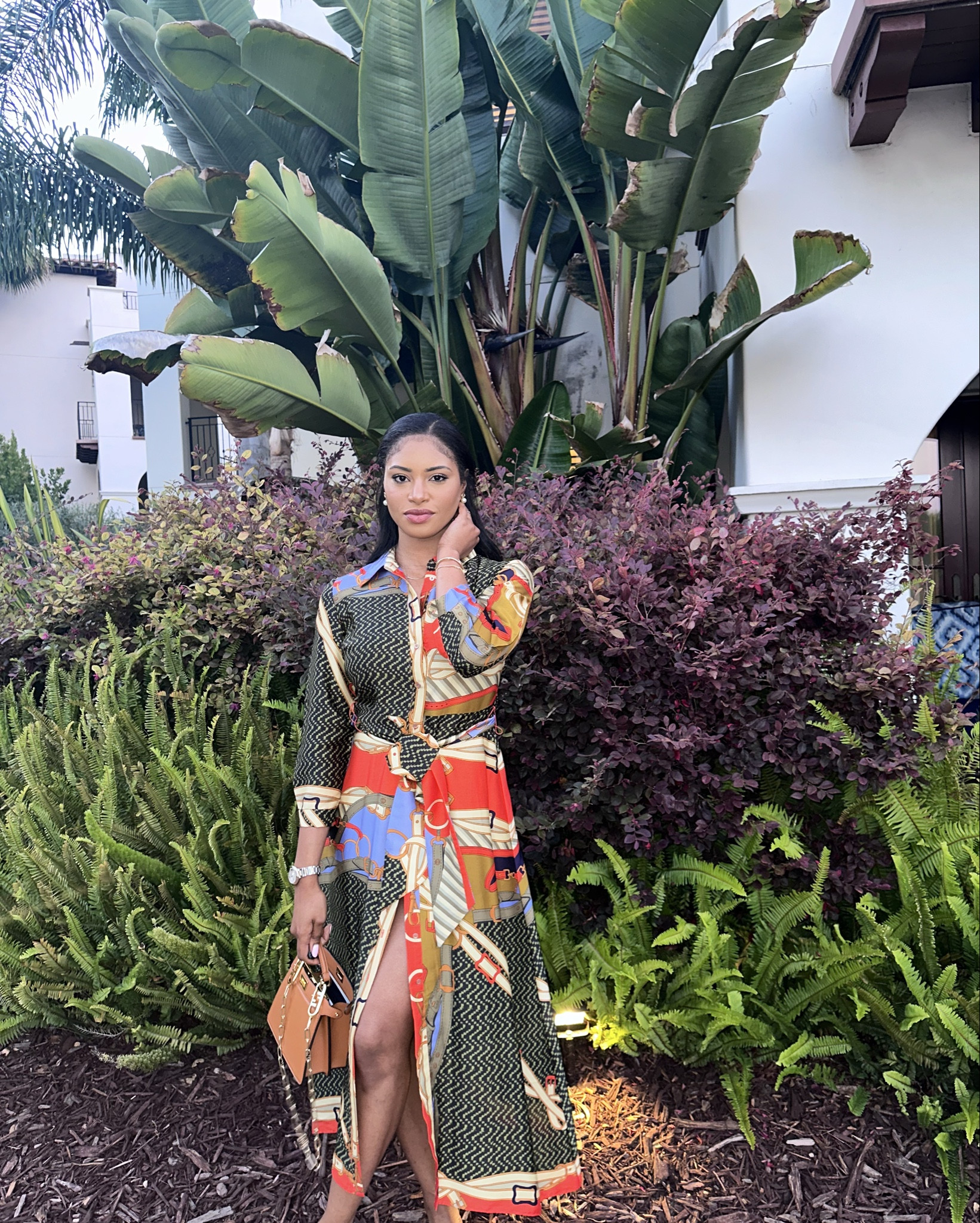 Prints that speak volumes 🎨✨
This bold, patterned shirt dress from Zara is a whole statement, and I’m here for it! From the rich color palette to the luxe chain and rope-inspired print, this dress does all the talking. The belted waist adds shape, while the front slit gives it just the right amount of drama. I styled it with a tan mini handbag and sleek slides for a sophisticated yet vacation-ready vibe.

📌 Perfect for a summer dinner date, tropical getaway, or when you just want to turn heads effortlessly.