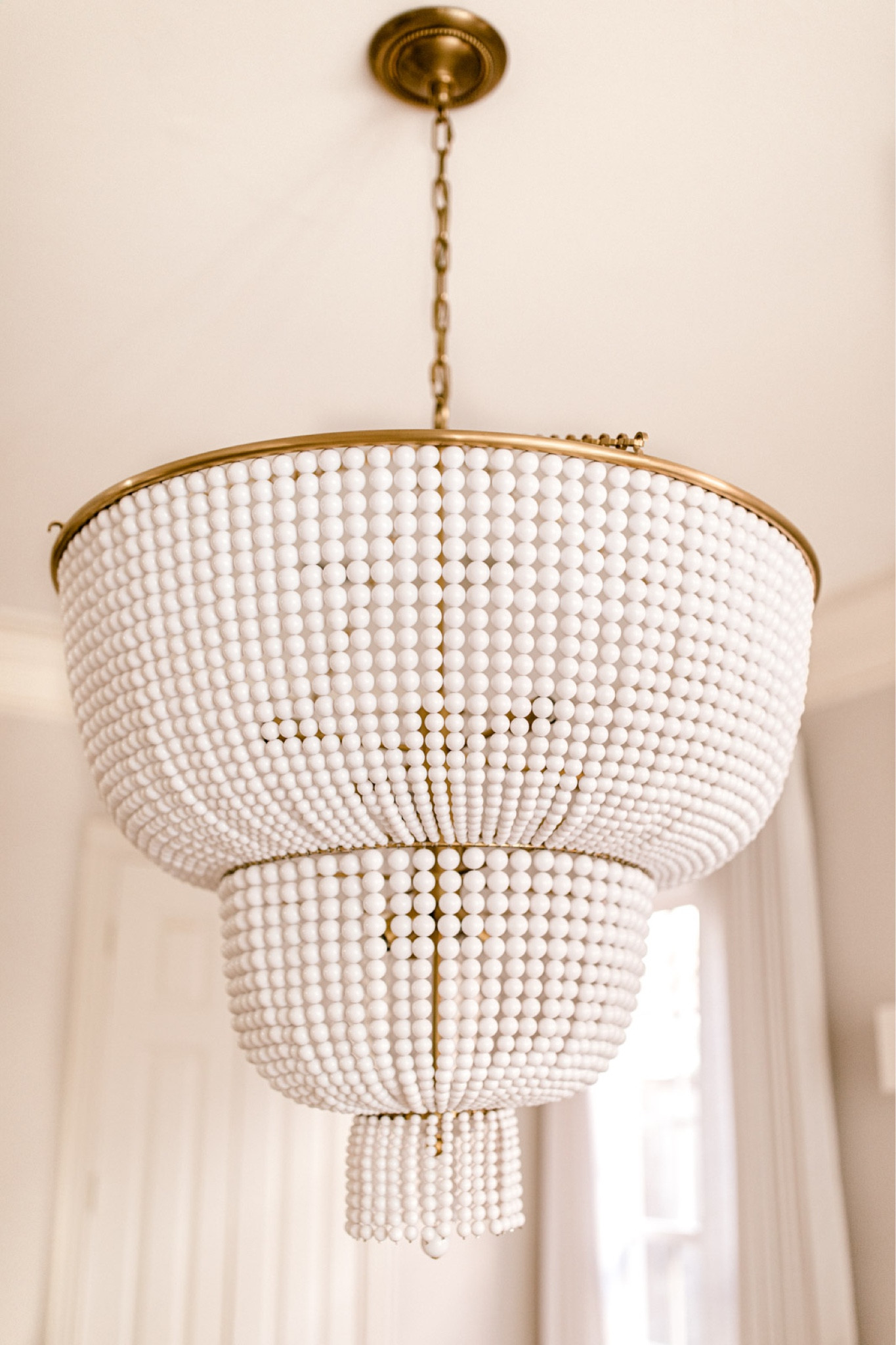 Gold and white beaded chandelier, tiered chandelier, three tiered chandelier, visual, comfort, chandelier, Jacqueline chandelier, brass, and white, large chandelier, Jackie chandelier, the look for a last designer luck, designer lighting 

#LTKFind #LTKstyletip #LTKhome