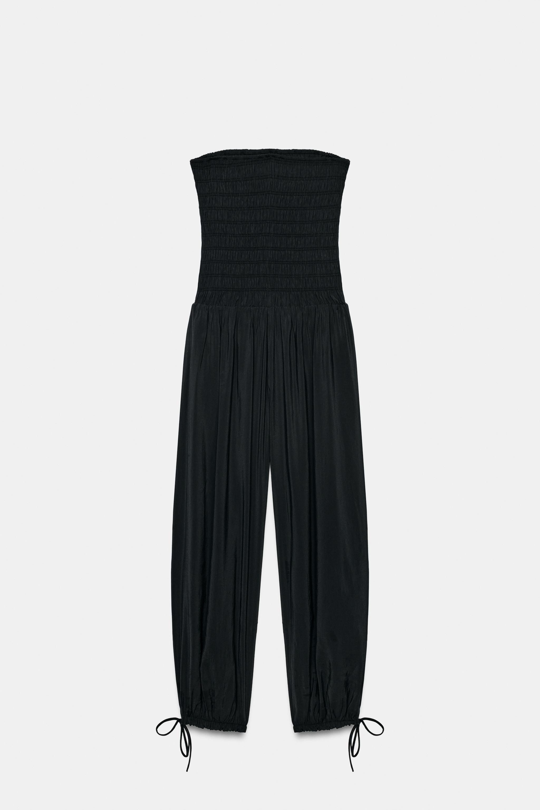 Jumpsuit made of flowy fabric. Straight neckline and off-the-shoulder design. Elastic gathered de... | Zara US
