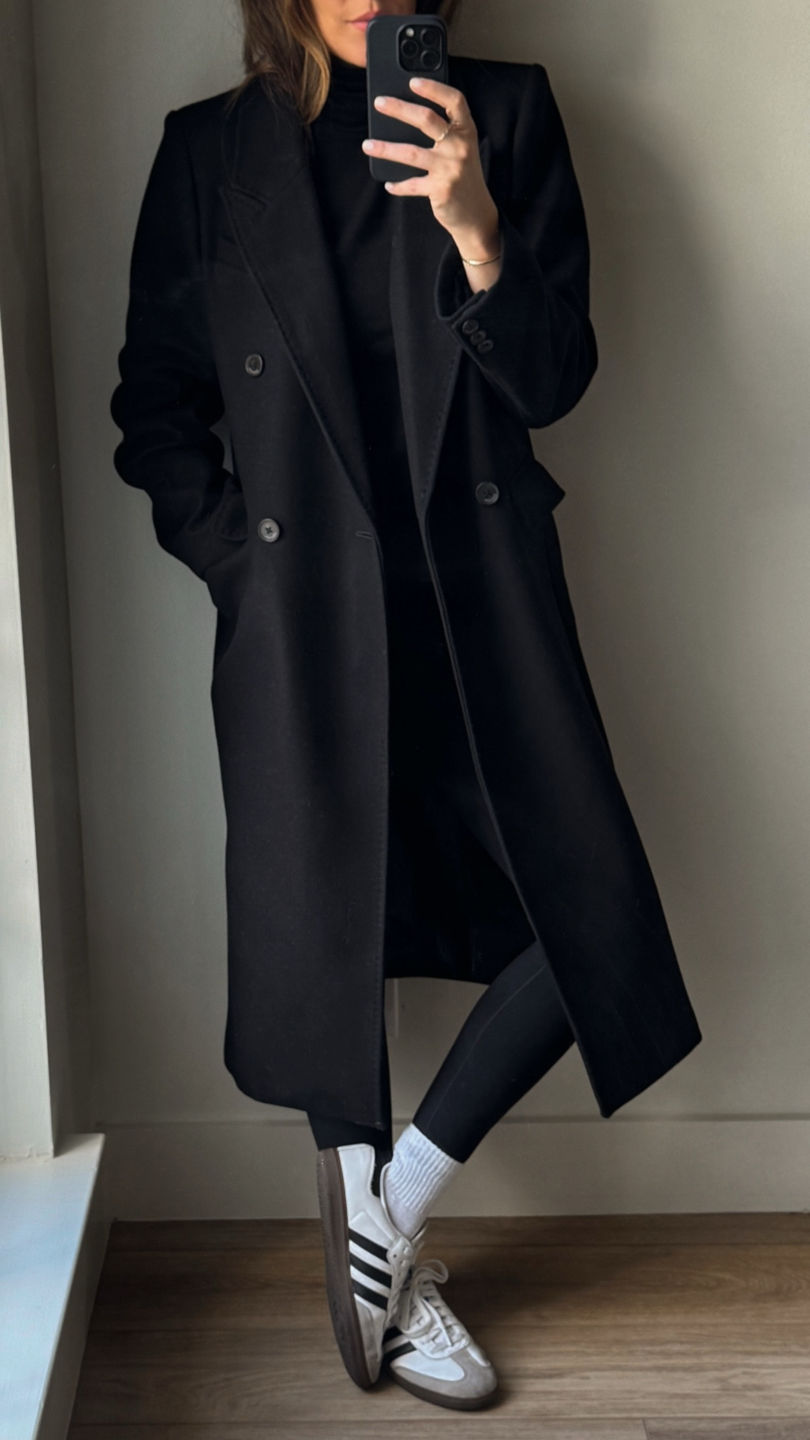 Aritzia long black coat, aritzia turtleneck, black leggings, and socks, adidas sambas
