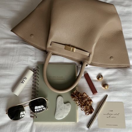 DeMellier New York bag, Ilia skin rewind foundation stick, Anine Bing aviator sunglasses, journal, white jade gua sha, Anisa Sojka earrings, Make Up by Mario plumping lip serum, tortoiseshell claw hair clip, silver pen, affirmation cards

#LTKstyletip #LTKbeauty #LTKitbag