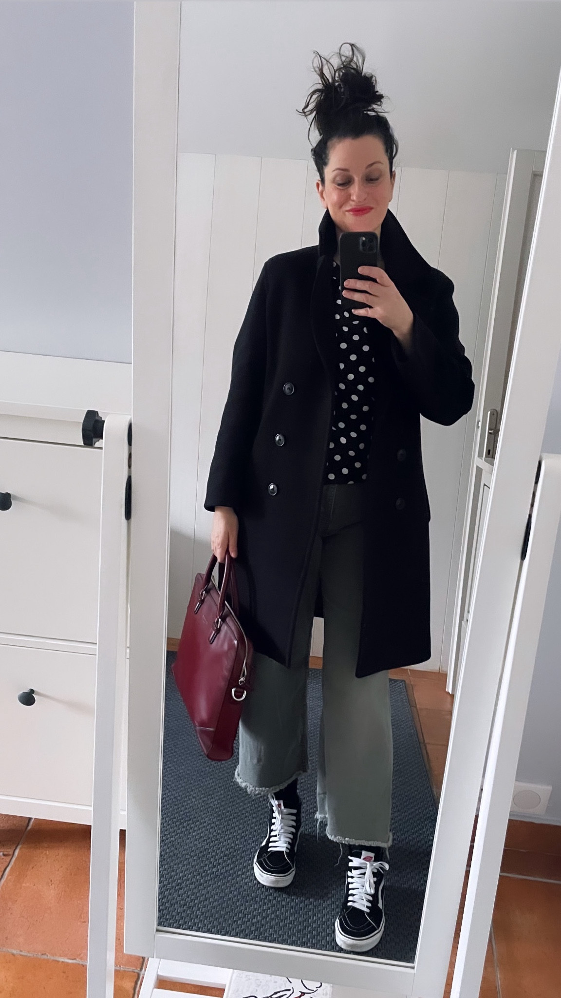 . Navy peacoat #pablo (linked) . Polka dot draped top #belairparis . Khaki barrel jeans #kiabi (similar, linked) . Black suede « Sk8 Hi » high tops #vans (linked) . Burgundy leather briefcase #letanneur . « Poppy red » lip balm pencil #labello (linked) 

#LTKmidsize #LTKover40 #LTKeurope