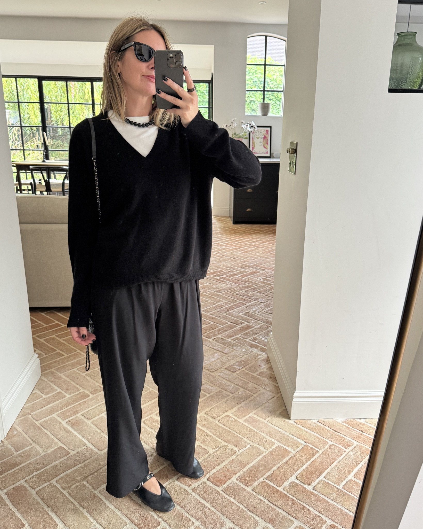 Black satin pants + V neck knit + white tee + ballet pumps | monochrome outfit | Chanel 

#LTKeurope #LTKautumn #LTKdatenight