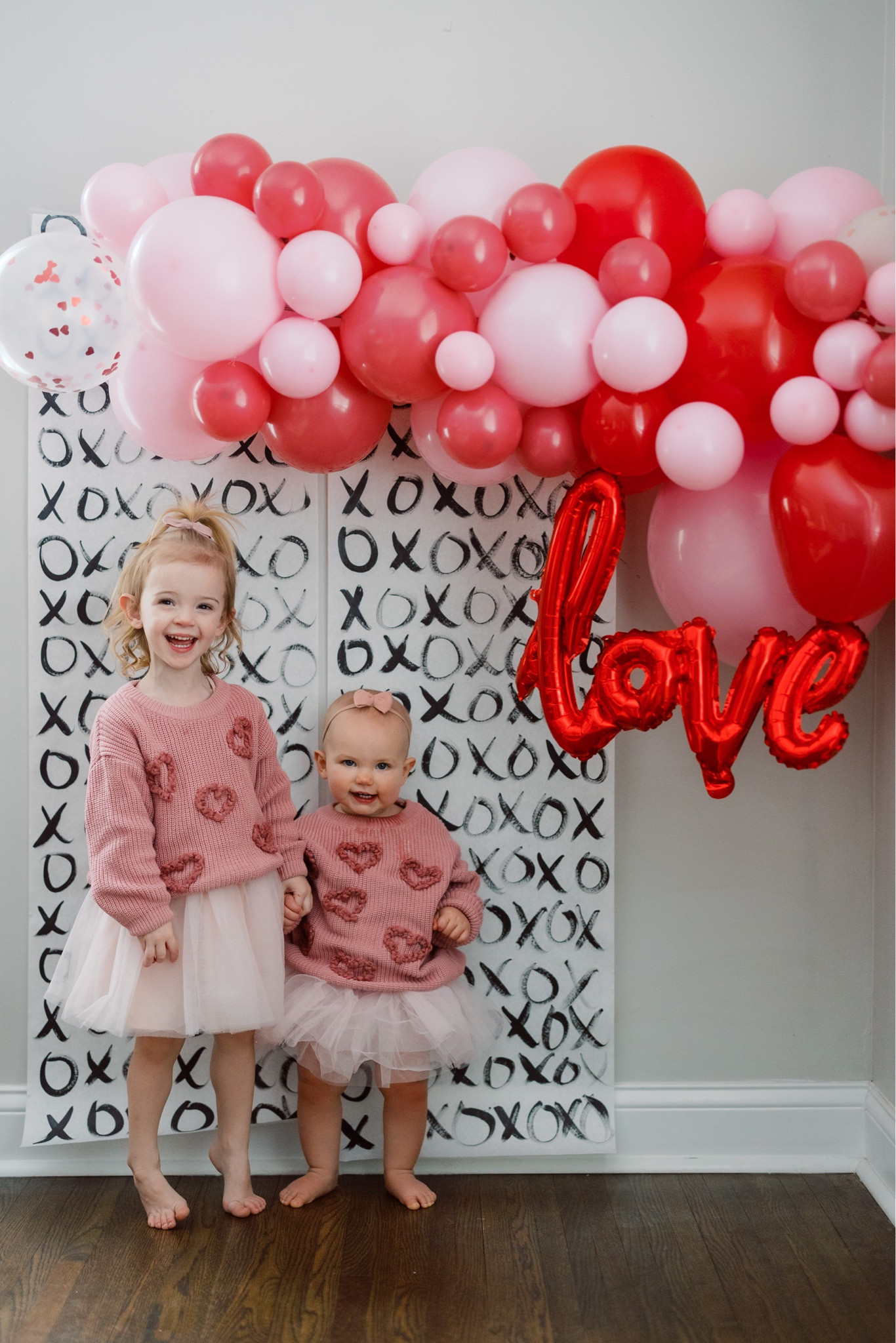 Valentines photo ideas! Backdrop only cost $12. Then we used paper and paint we already had. Perfect for kids. Holiday sister photos. DIY sweaters

#LTKbaby #LTKSeasonal #LTKkids