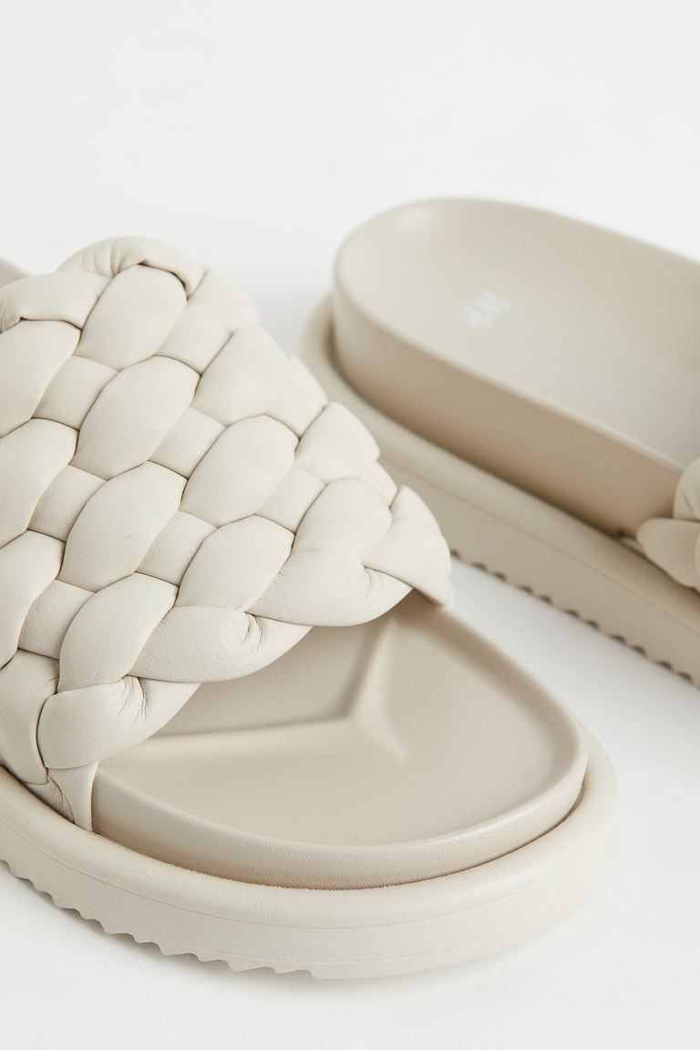 Slides in faux leather with a wide, braided foot strap. Molded soles with patterned base. Sole th... | H&M (US + CA)