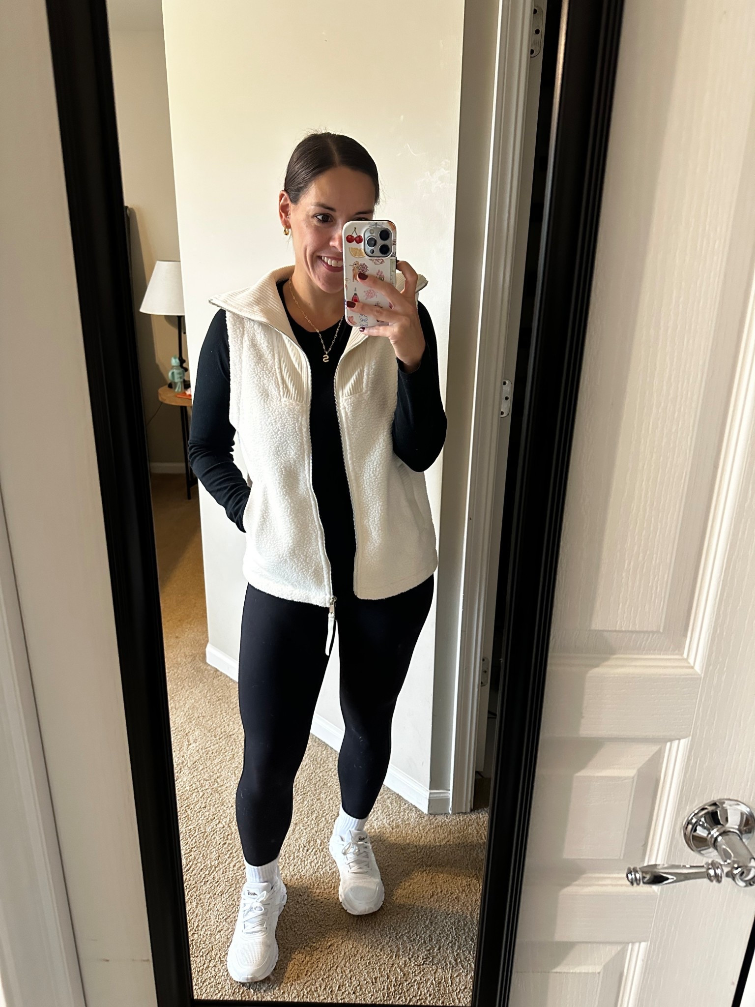 This cozy and casual fall outfit is a go-to for busy moms who want to look cute while staying comfortable. I’m wearing a white sherpa fleece zip-up vest, black long-sleeve top, high-waisted black leggings, and white sneakers…all from Amazon. It’s the perfect outfit for school drop-off, errands, or kids’ sports days when you still want to feel put-together.

This Amazon fall outfit is a staple in my wardrobe because it’s easy to mix and match with puffer vests, flannels, or cardigans. Add gold jewelry and a slick bun for a polished, minimal look.