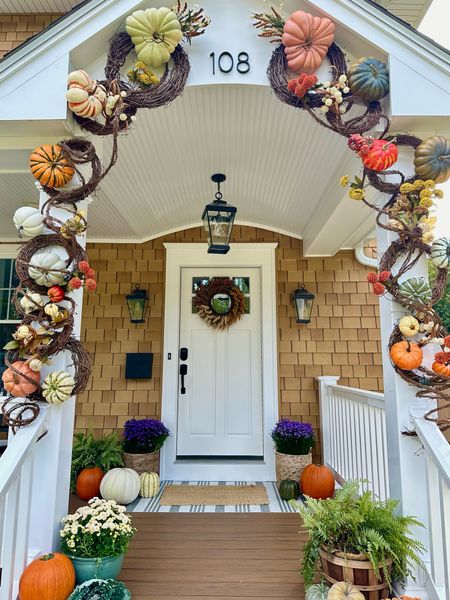 Front porch fall decor. Grapevine arch filled with faux pumpkins and florals #falldecor #porchdecor 

#LTKhome #LTKSeasonal