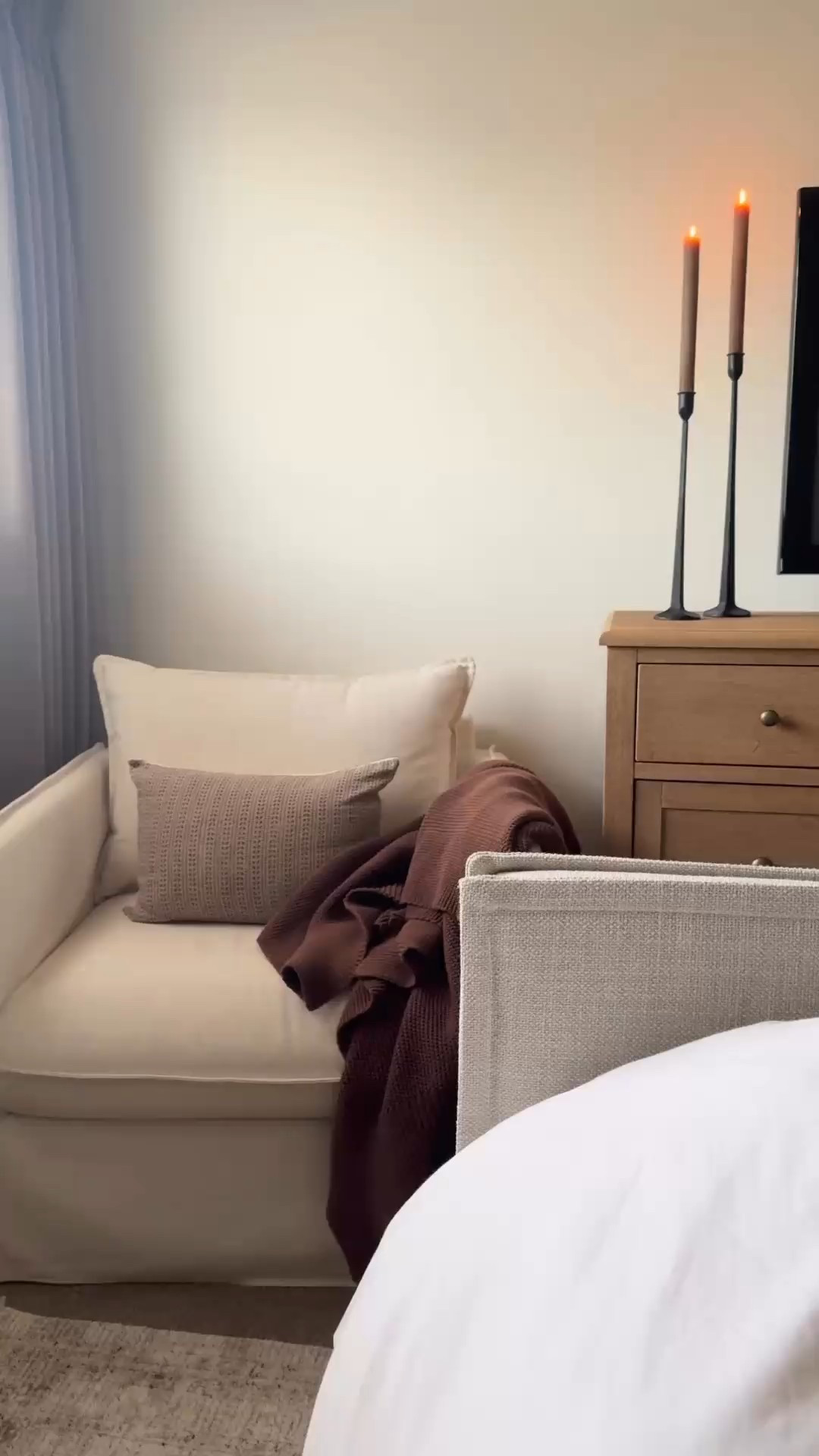 Cozy bedroom, cream chair, brown candlesticks, brown throw pillow, brown throw blanket, oak dresser, white vase, Norfolk pine stems, iron candlesticks, brown ribbed candlesticks, brown curtains

#LTKSeasonal #LTKSaleAlert #LTKHome